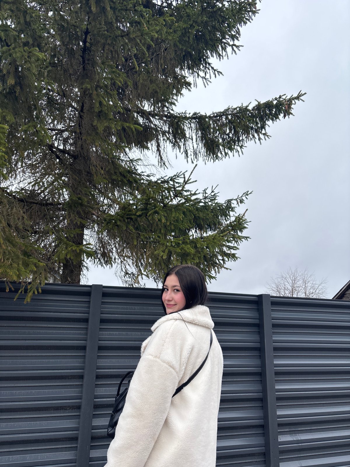 Woman takes selfie in grey sweater in Фоки, Russia
