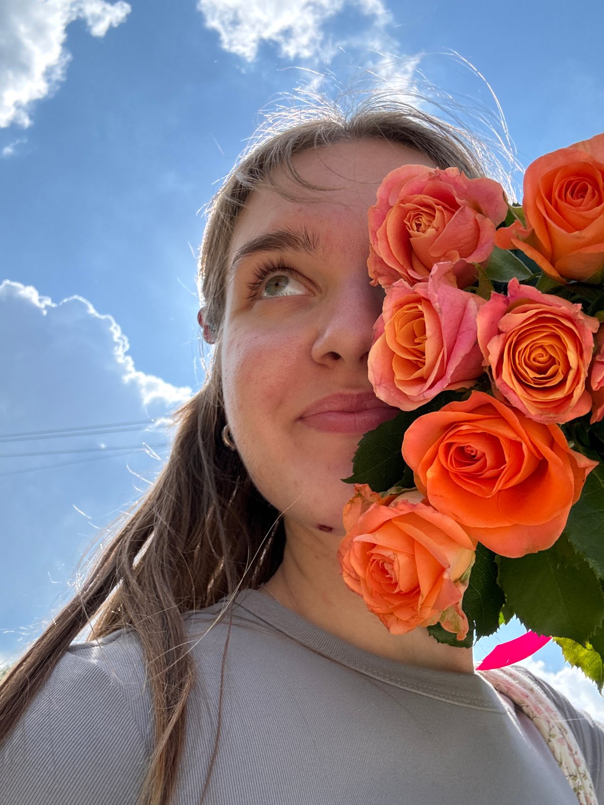 Flower selfies on a sunny rural road in Prikamskii, Russia