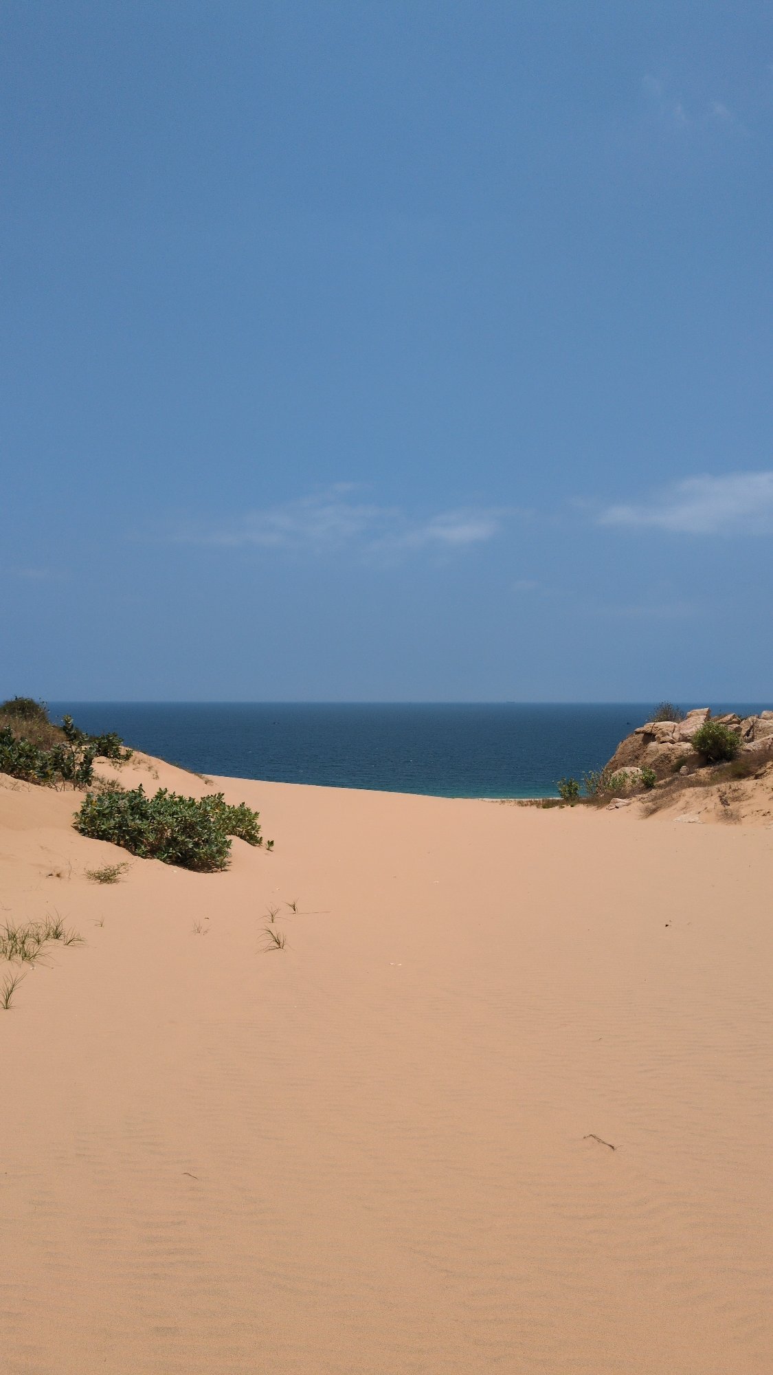 Person rests on Vietnam's Mui Dinh sand dunes morning