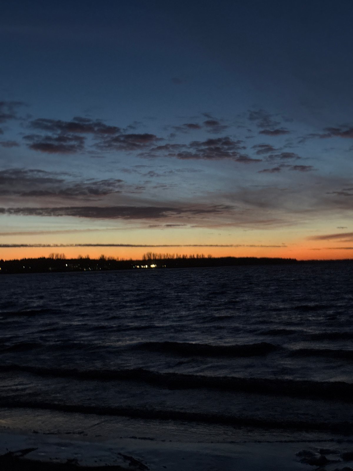 Sunset observed over water near Riga, Latvia