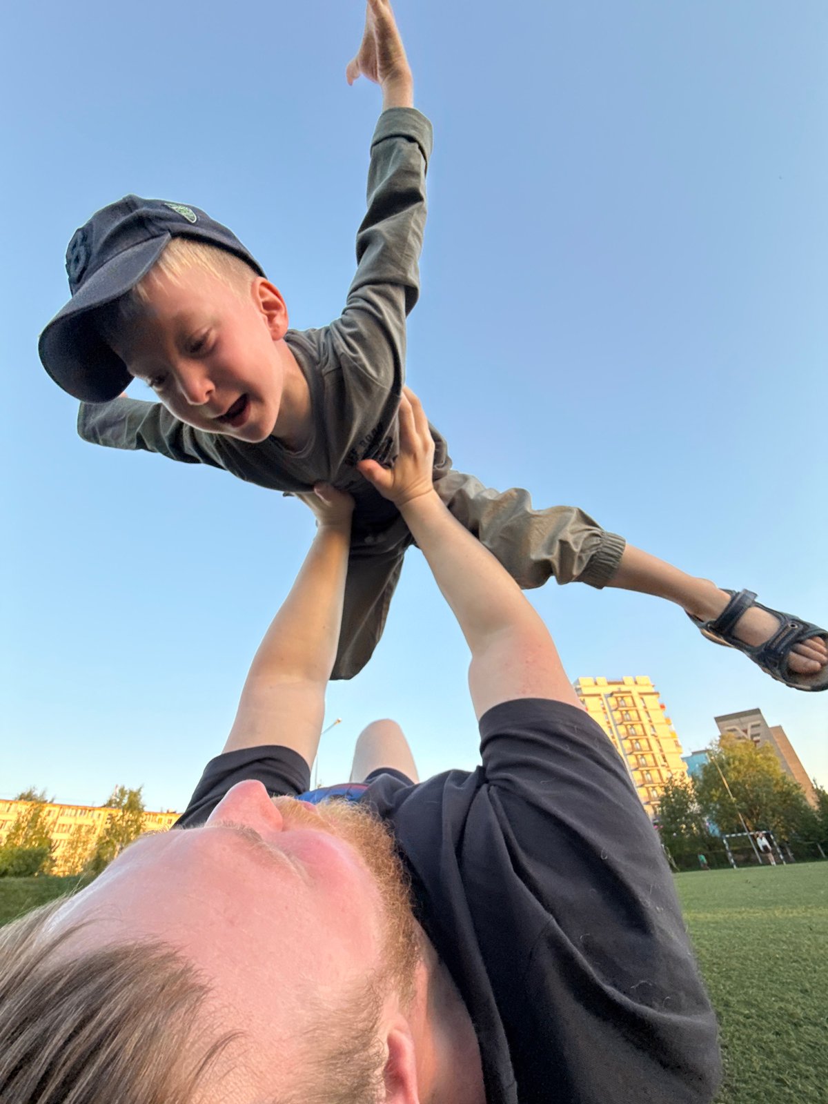Family enjoys afternoon playtime at Chaikovsky park with dog