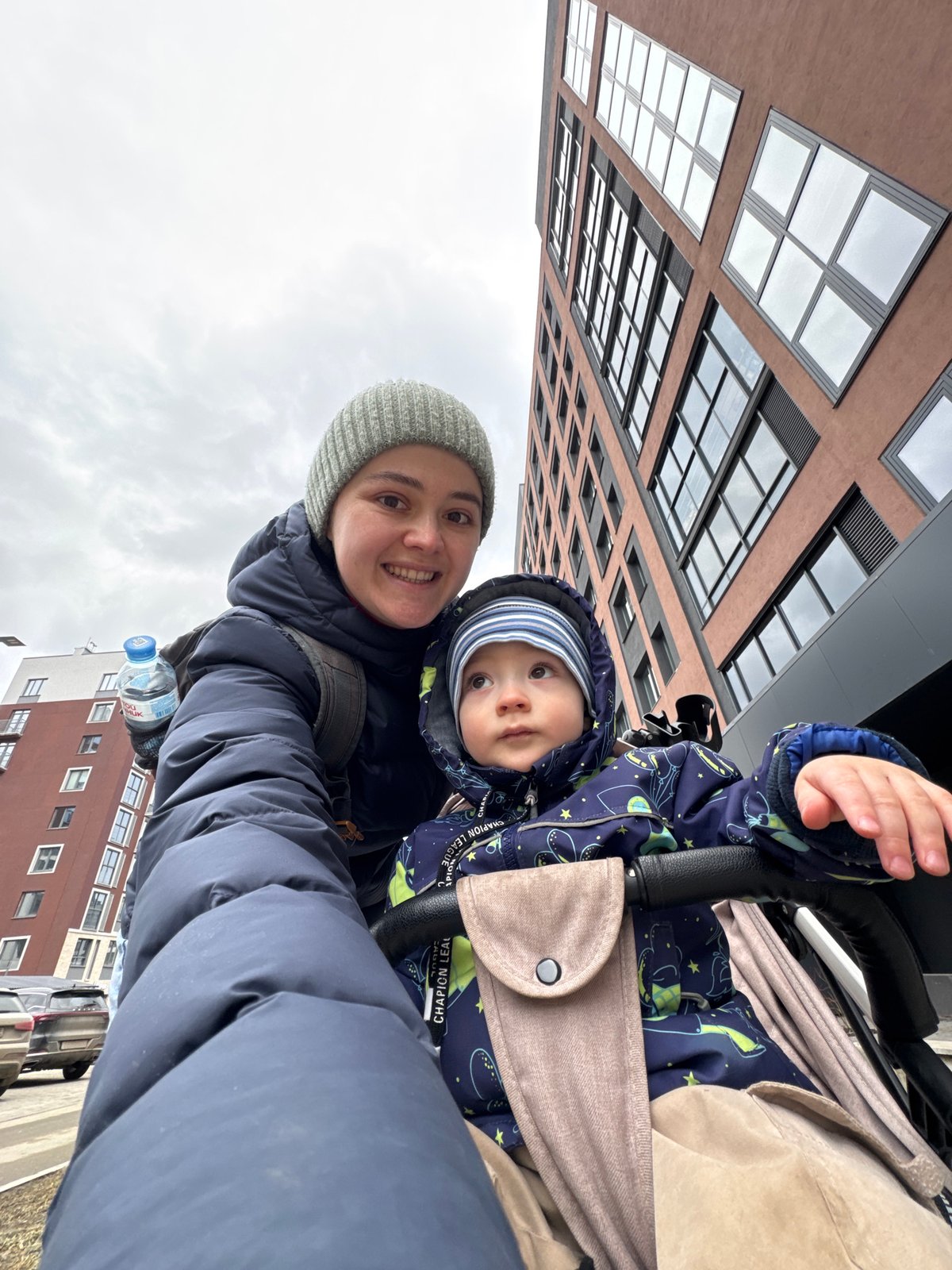 Woman takes selfie with baby; crow feeds in Izhevsk