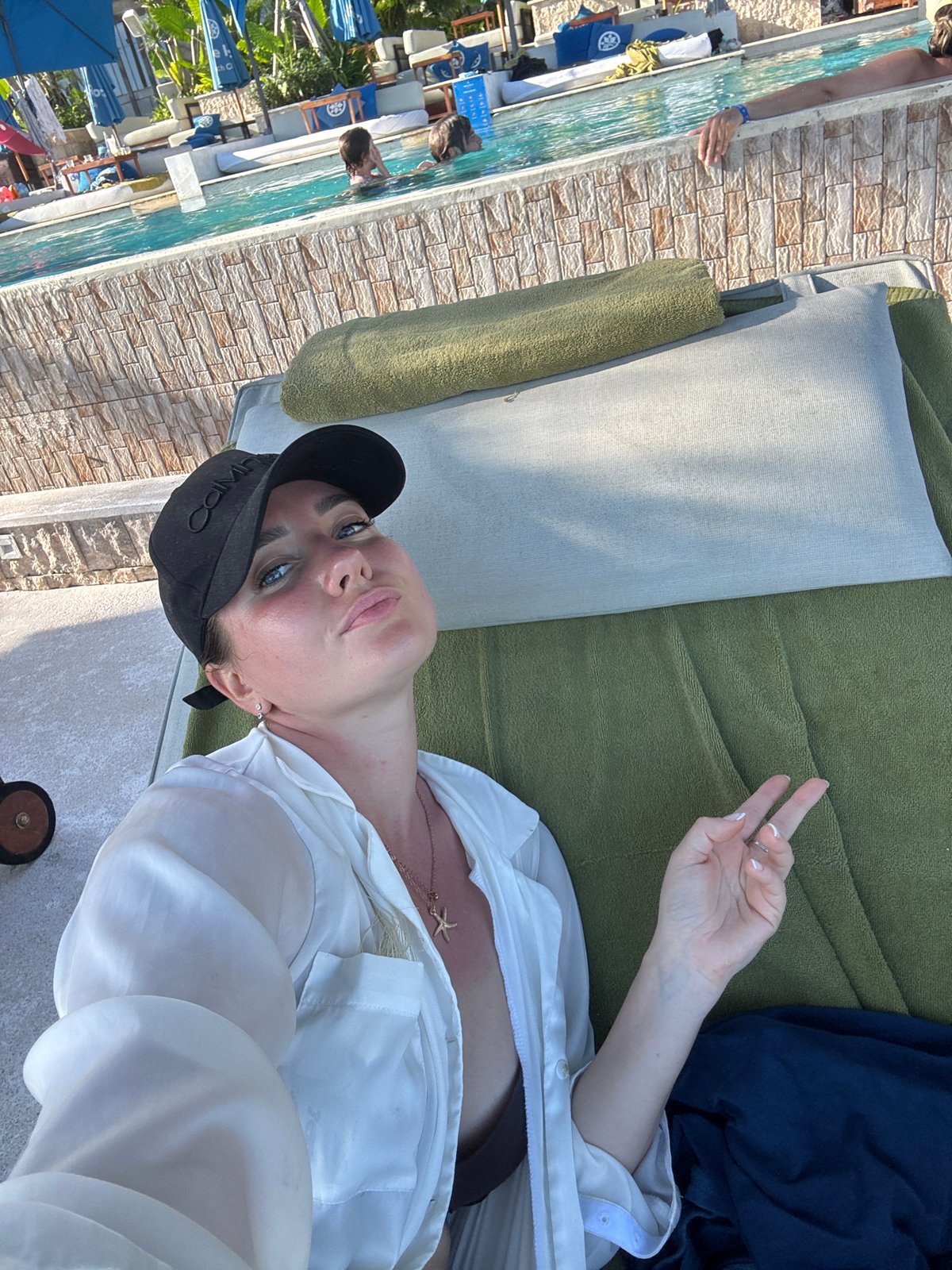 Tourist relaxes poolside at Kuta Selatan resort