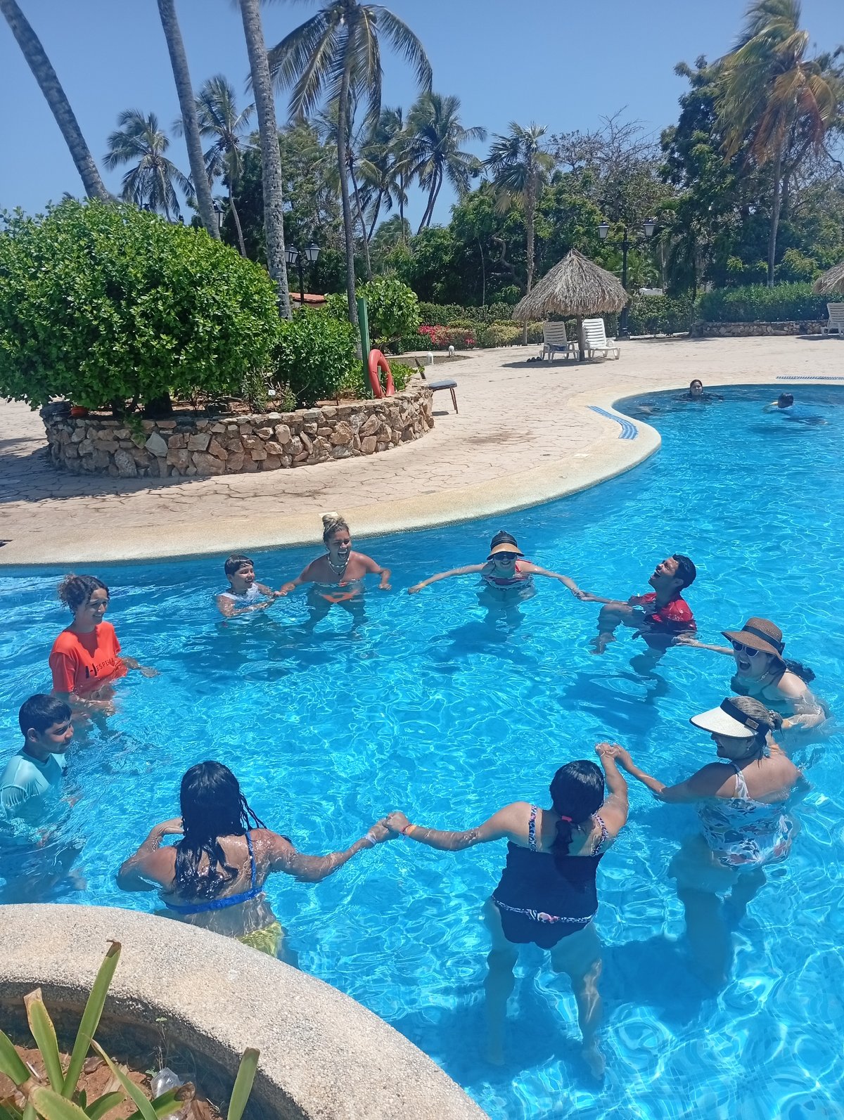 Family Circle Forms in Tropical Pool Setting