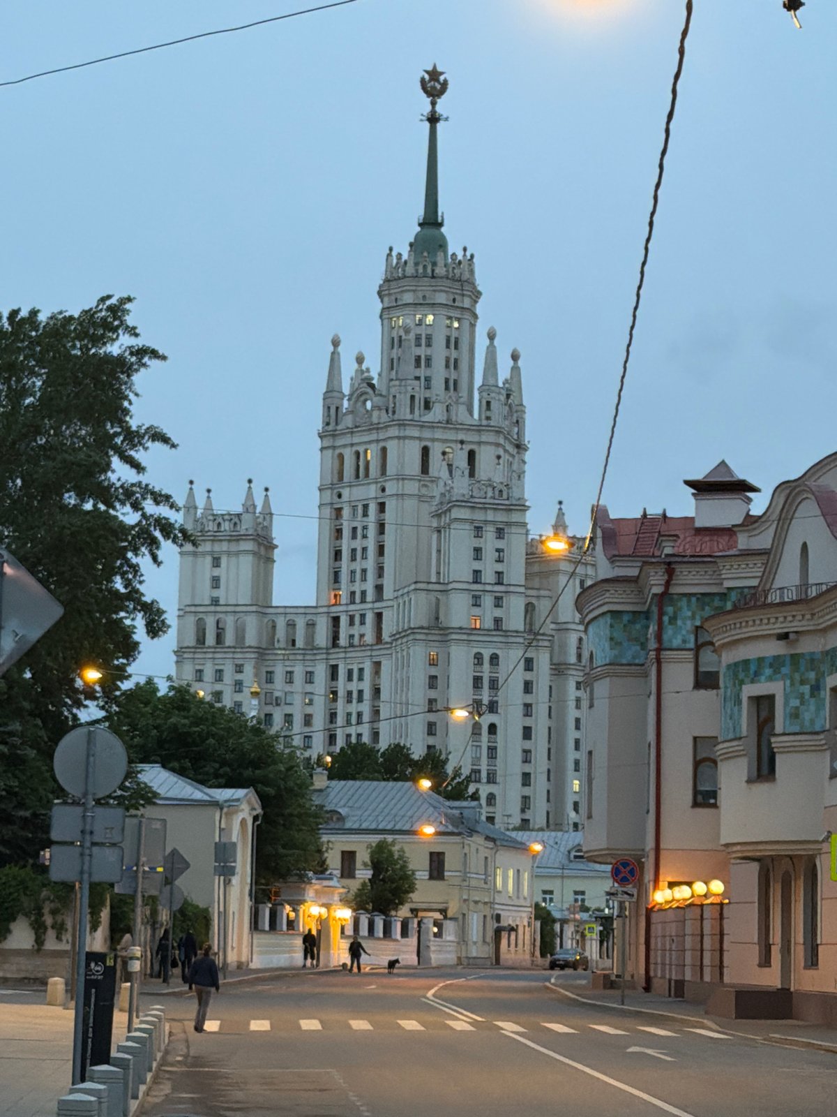 Woman films herself near Moscow's Stalinist skyscraper at dusk