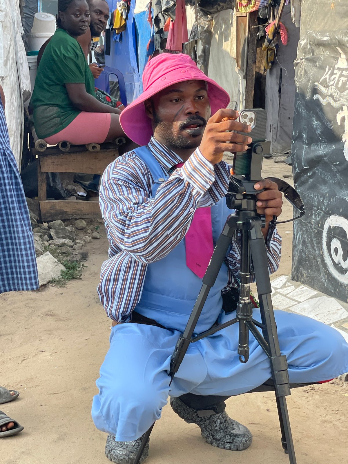 Man films with smartphone on tripod in Iranla, Nigeria