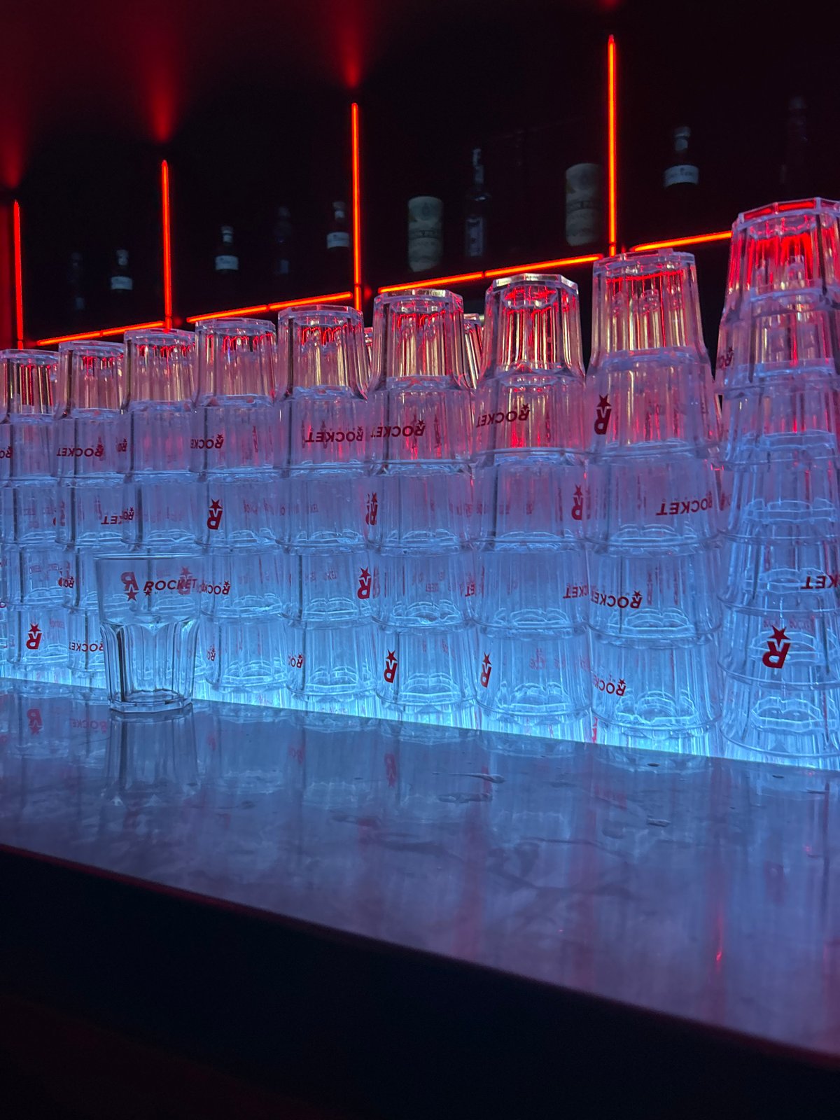 Bar setup with romantic neon signage documented in Milan