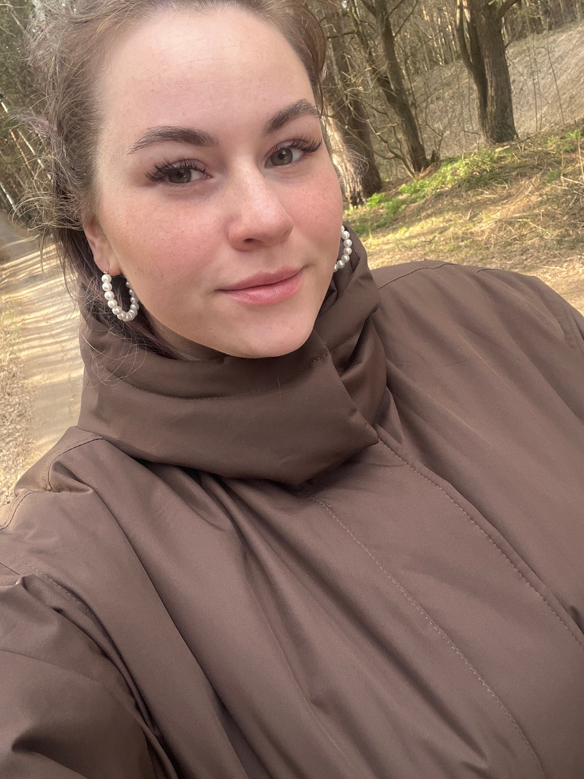 Woman takes selfies on forest road in Chaikovsky