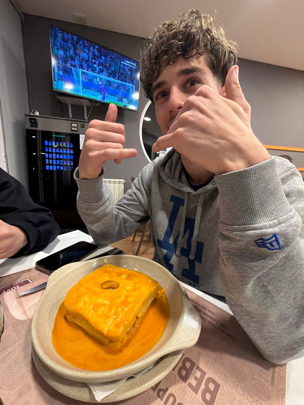 Diners review menus at Bragança restaurant