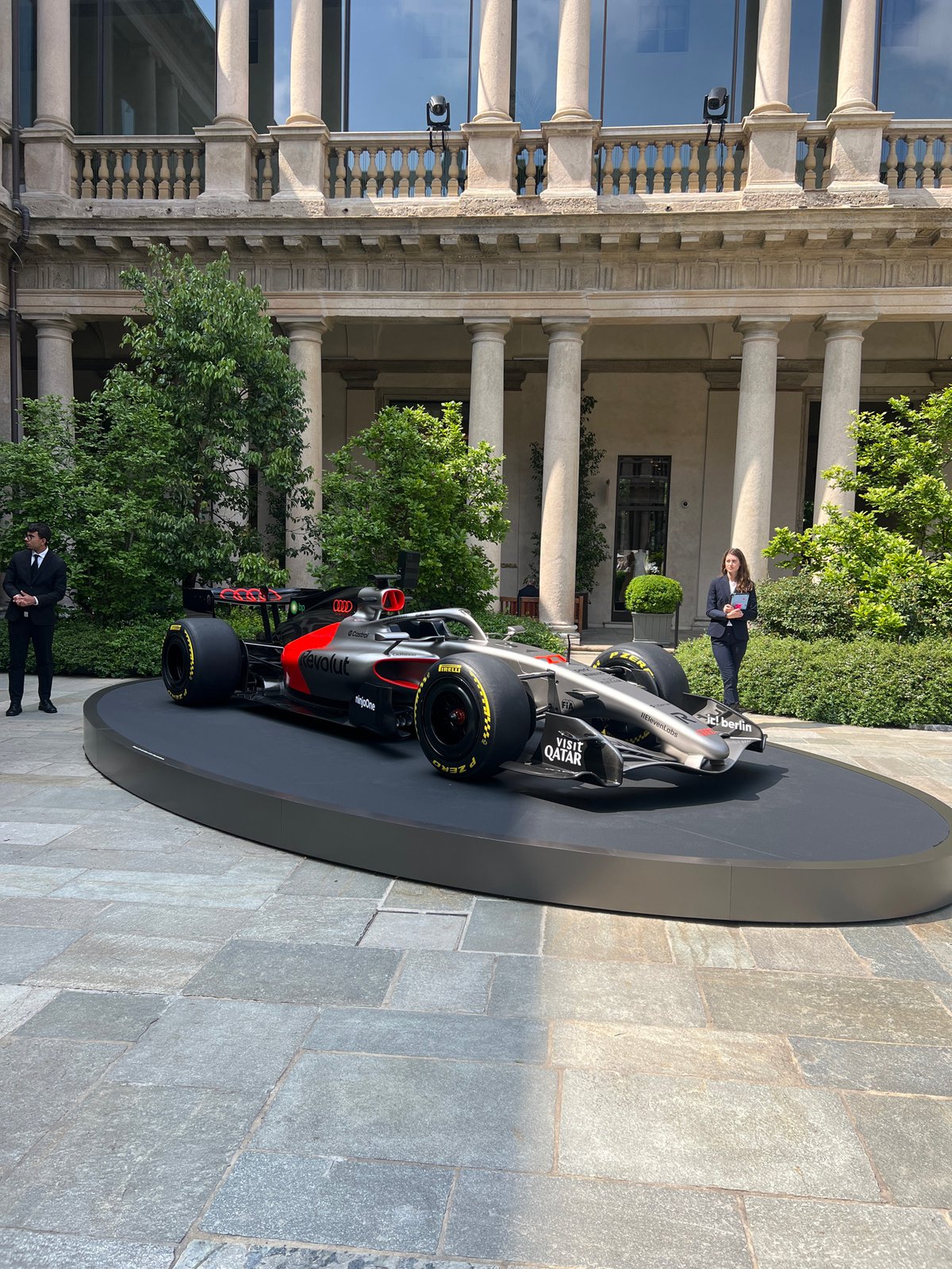 Formula 1 car displayed outside classical Milan building