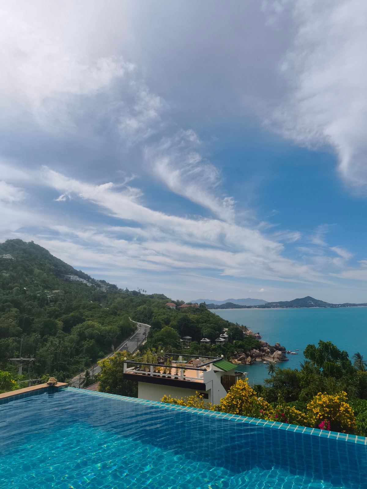 Morning poolside reading session overlooking Ko Samui coastline
