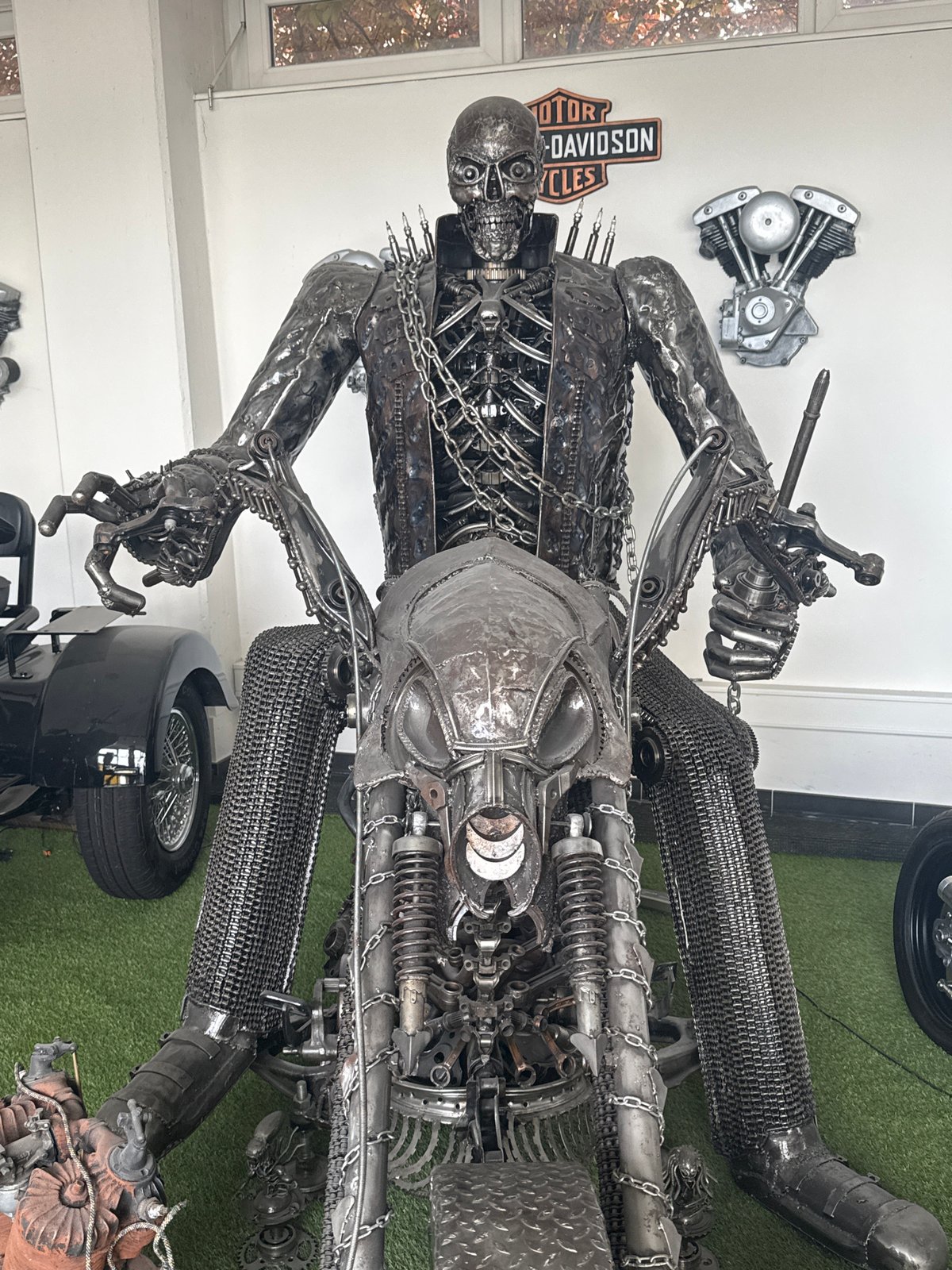 Visitor photographs metal motorcycle sculptures in German exhibition