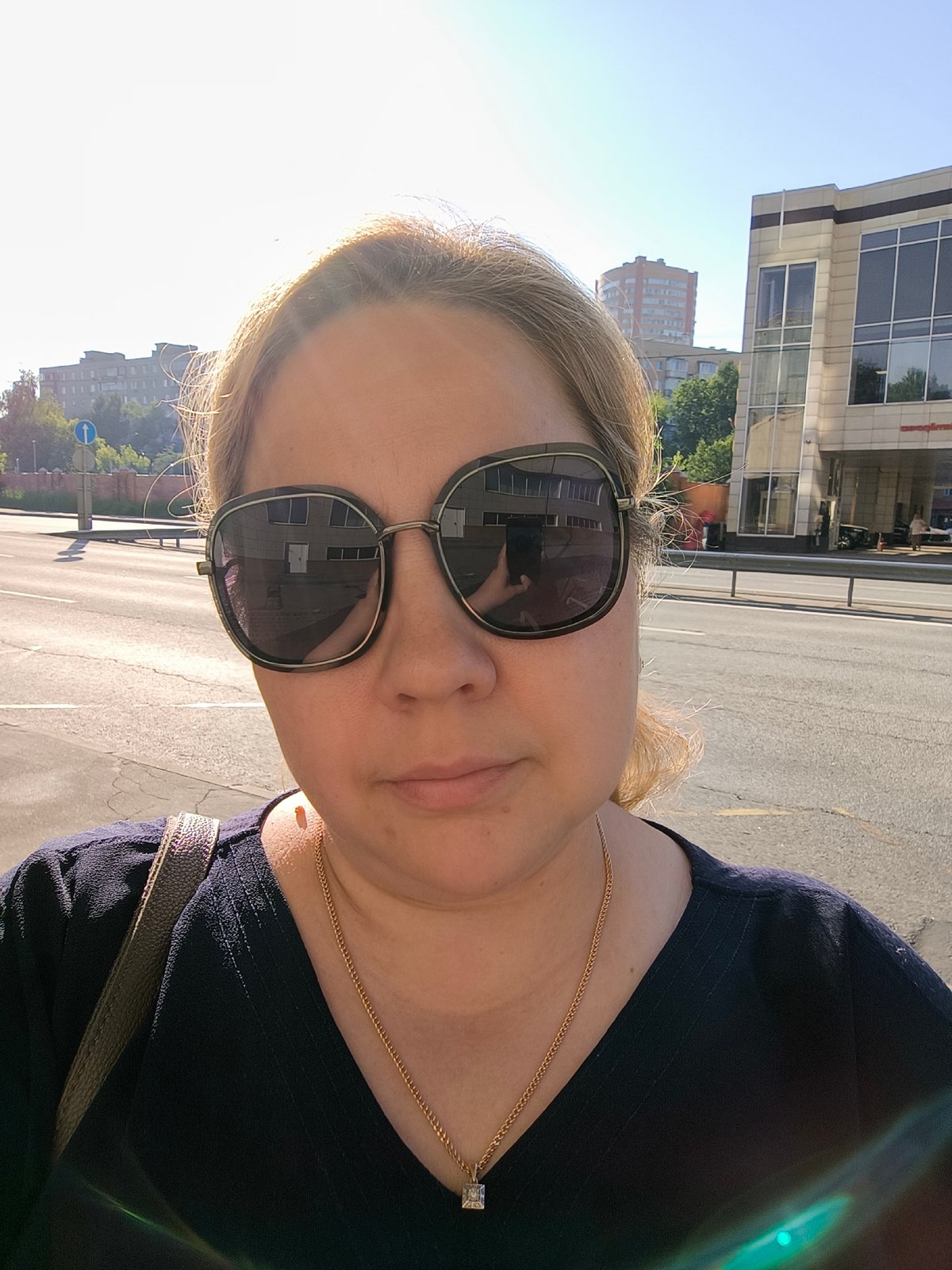 Woman takes early morning selfie on Moscow sidewalk