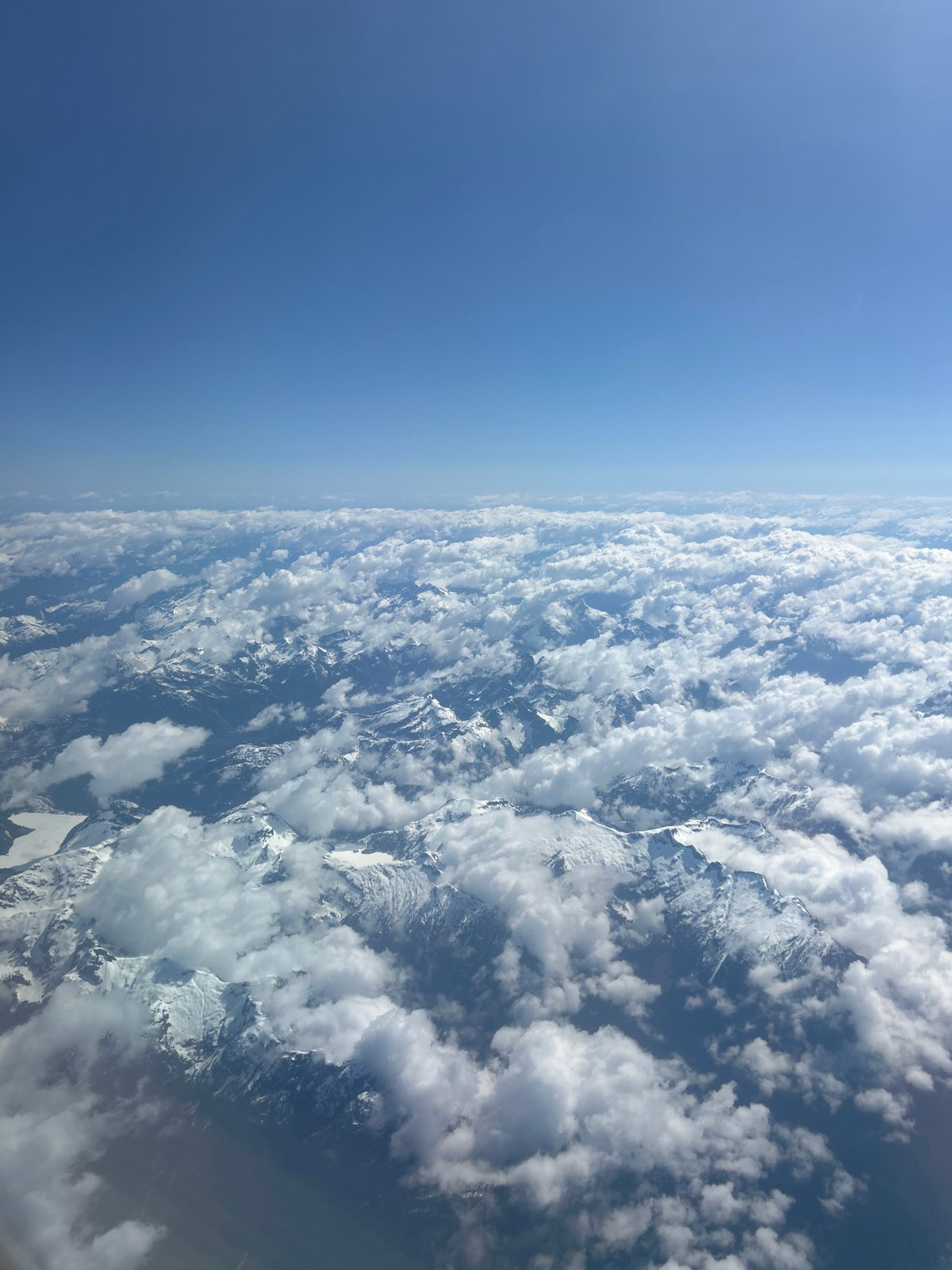 Aerial views capture clouds over Kelowna mountains