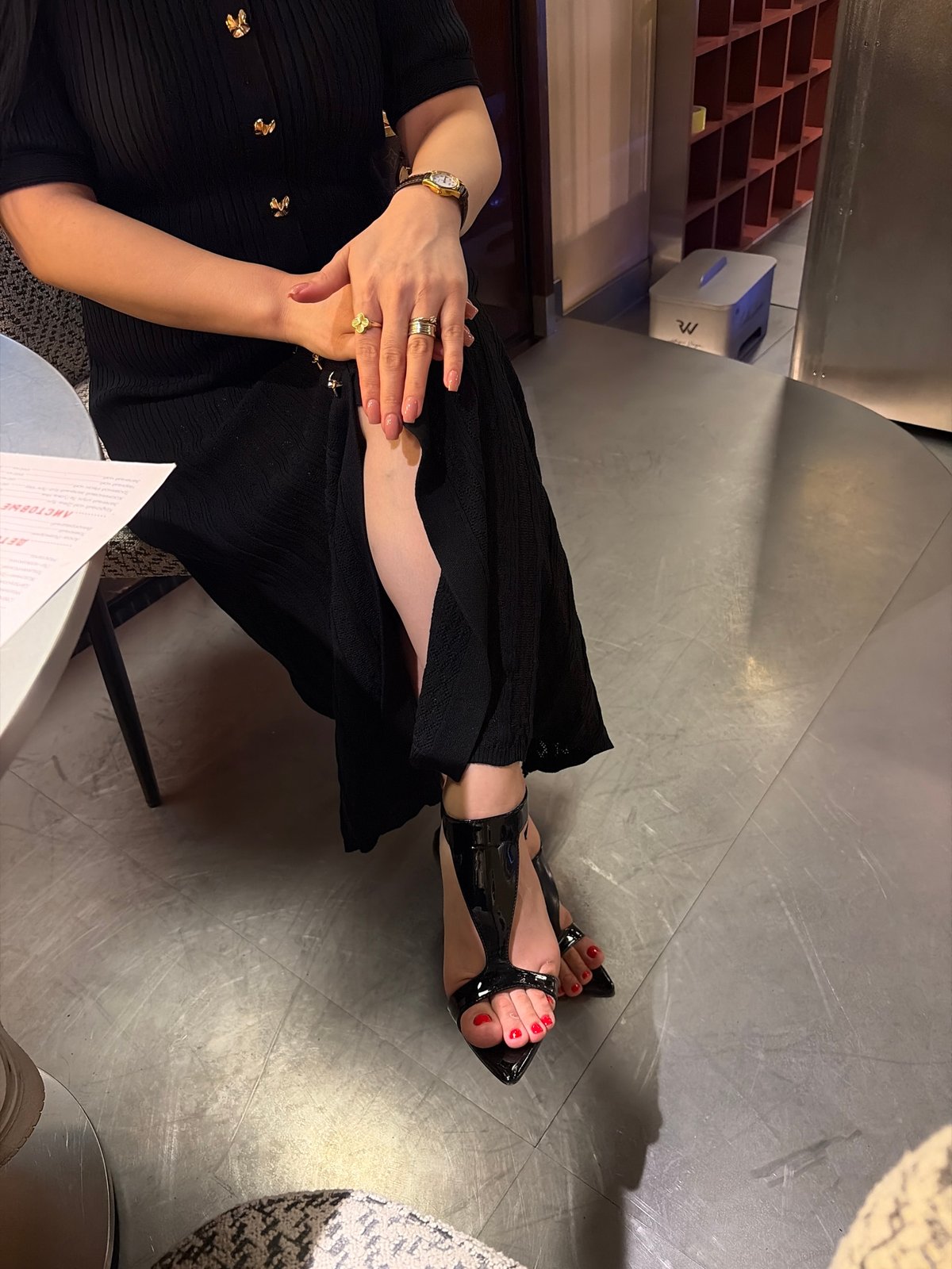 Woman in black dress visits Astana bakery, handles cosmetics