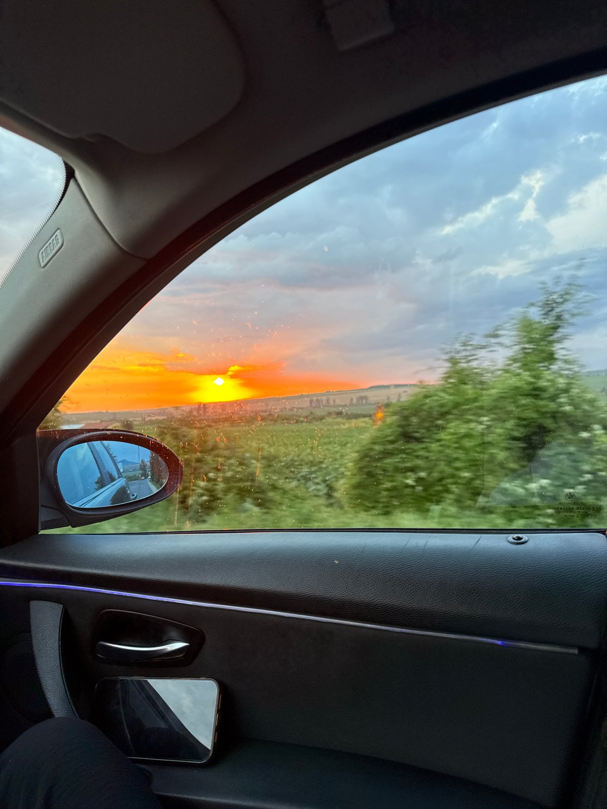 Sunset breaks through dark clouds over rural Probuda, Bulgaria