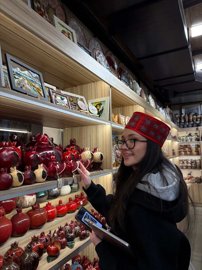 Tattooed visitor shops traditional Armenian crafts at Yerevan market