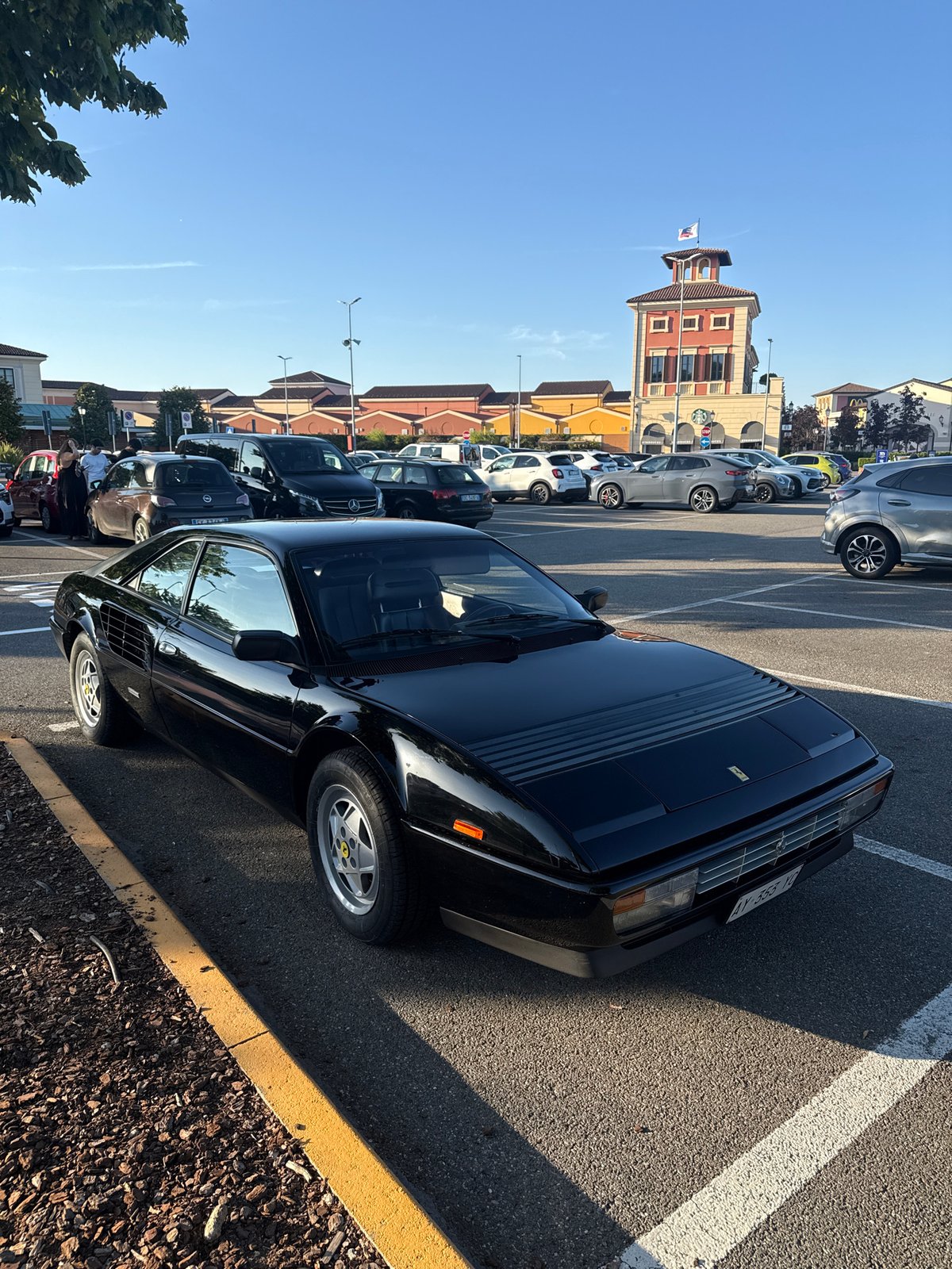 Black Ferrari Mondial T parked in Serravalle Scrivia lot