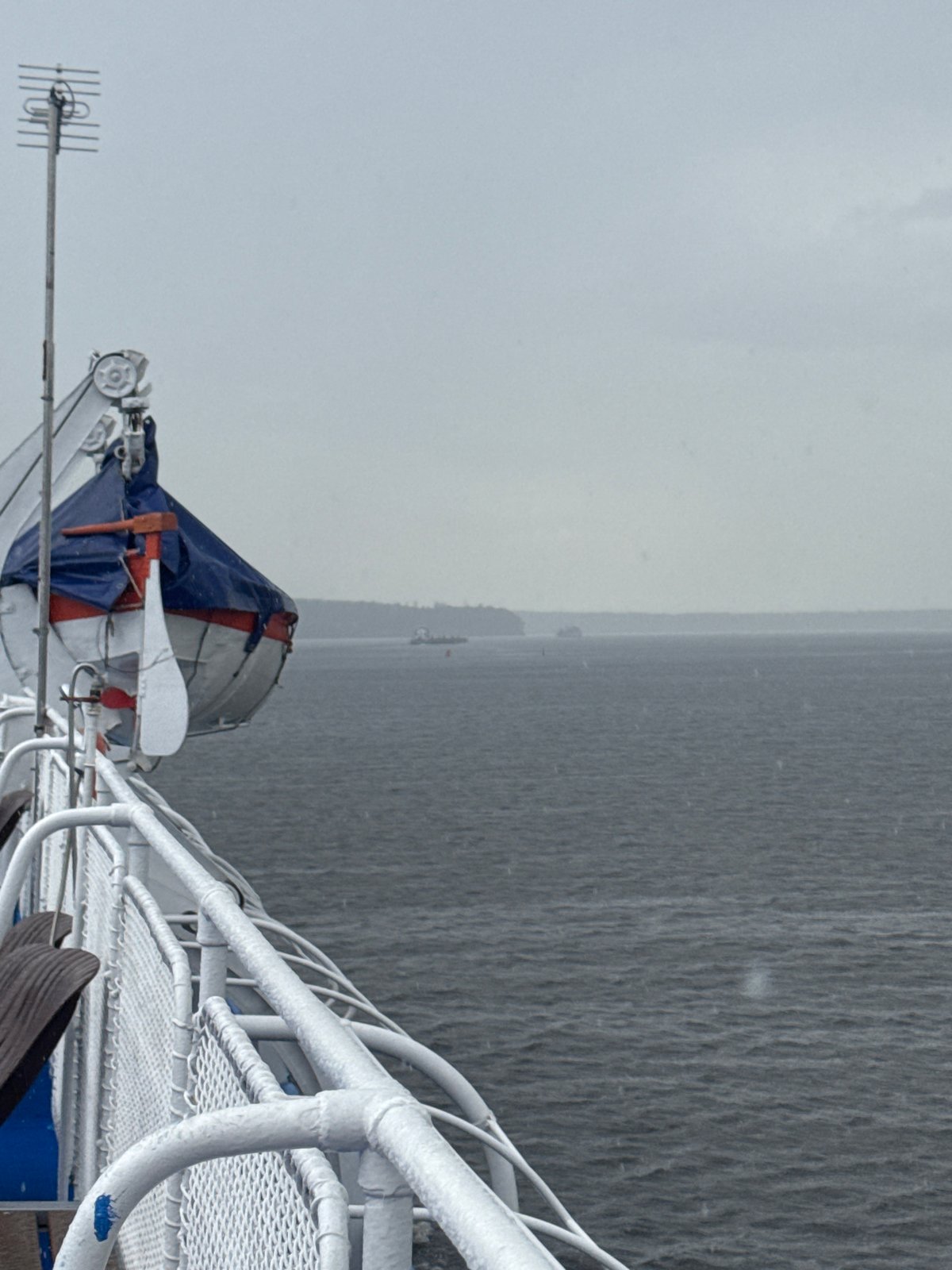 Ferry deck view over grey Russian waters in overcast conditions