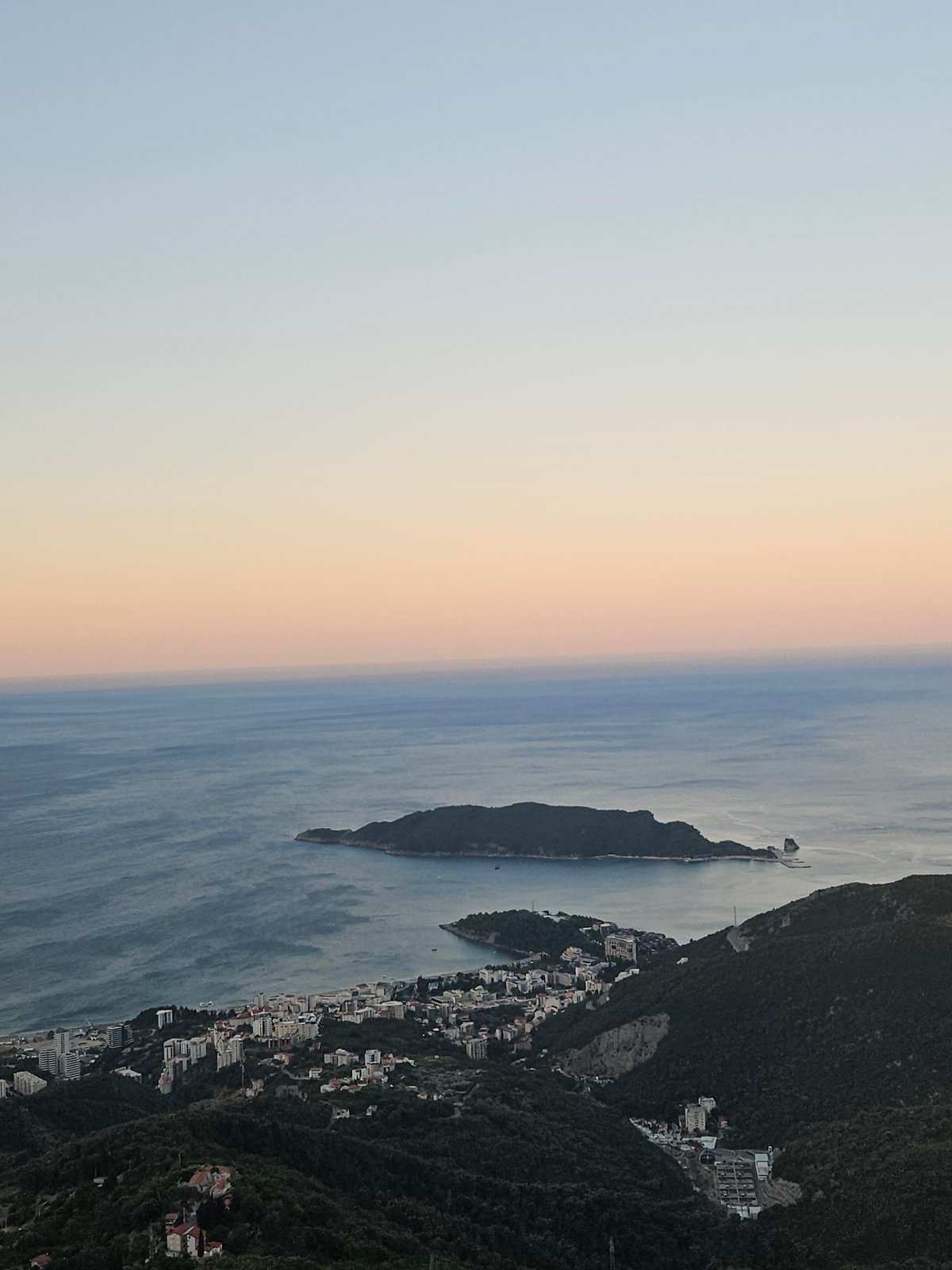 Budva's coastline at dusk, layered sky and sea.