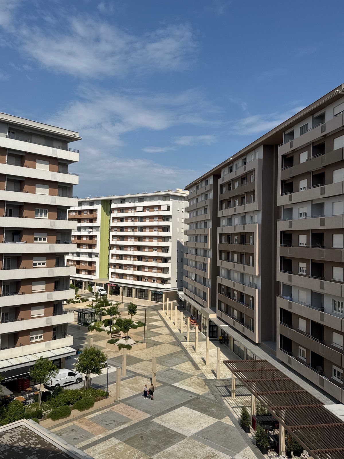 Modern apartment courtyard seen from ground and aerial angles