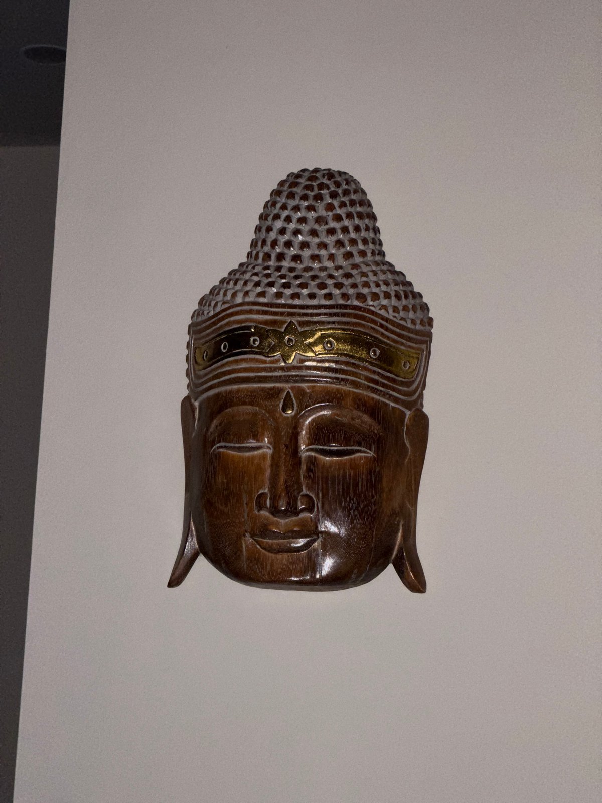 Decorative Buddha sculpture observed on wall in Kalibukbuk, Indonesia