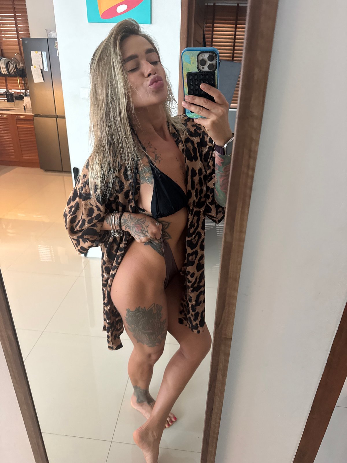 Woman takes mirror selfies in leopard print in Thailand