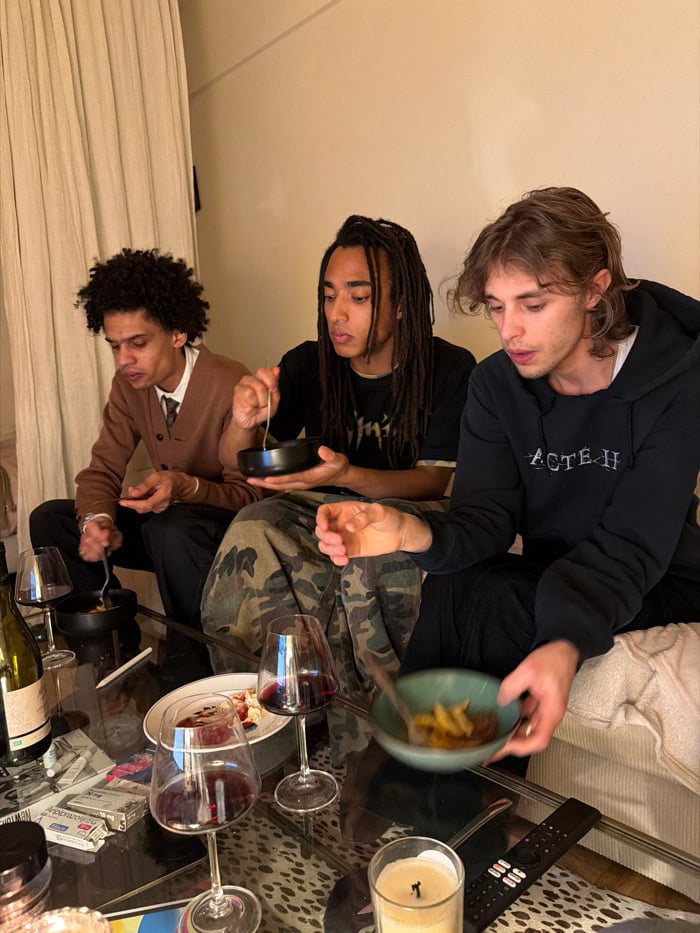 Young men share casual evening meal in Paris residence