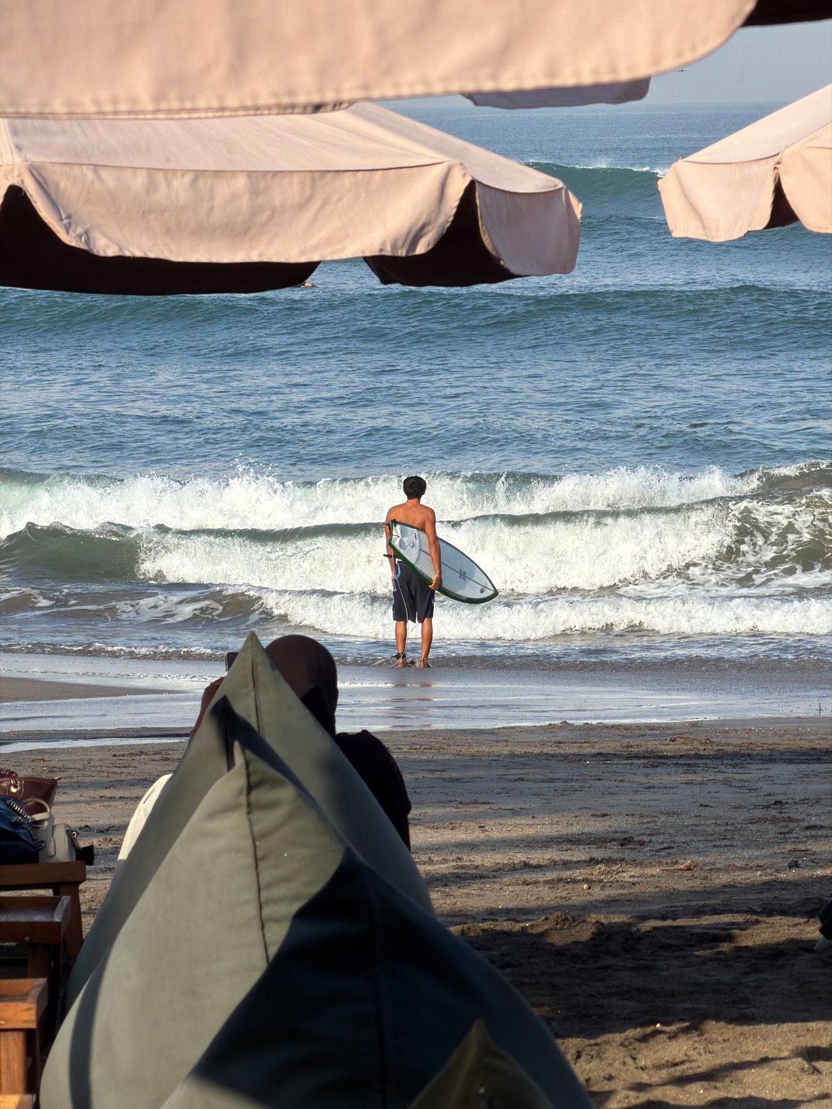 Surfers, beachgoers, and café life on a North Kuta morning