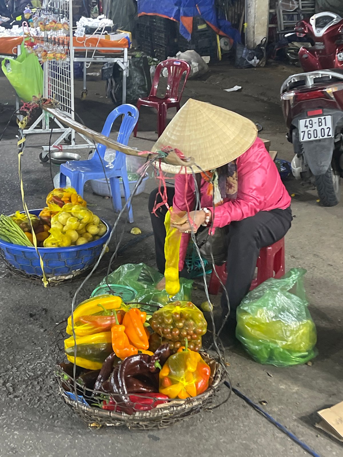 Street vendor sells fresh produce at Da Lat market