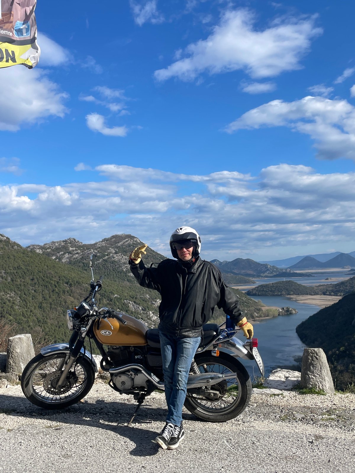 Motorcyclist pauses at Montenegro river overlook for scenic views