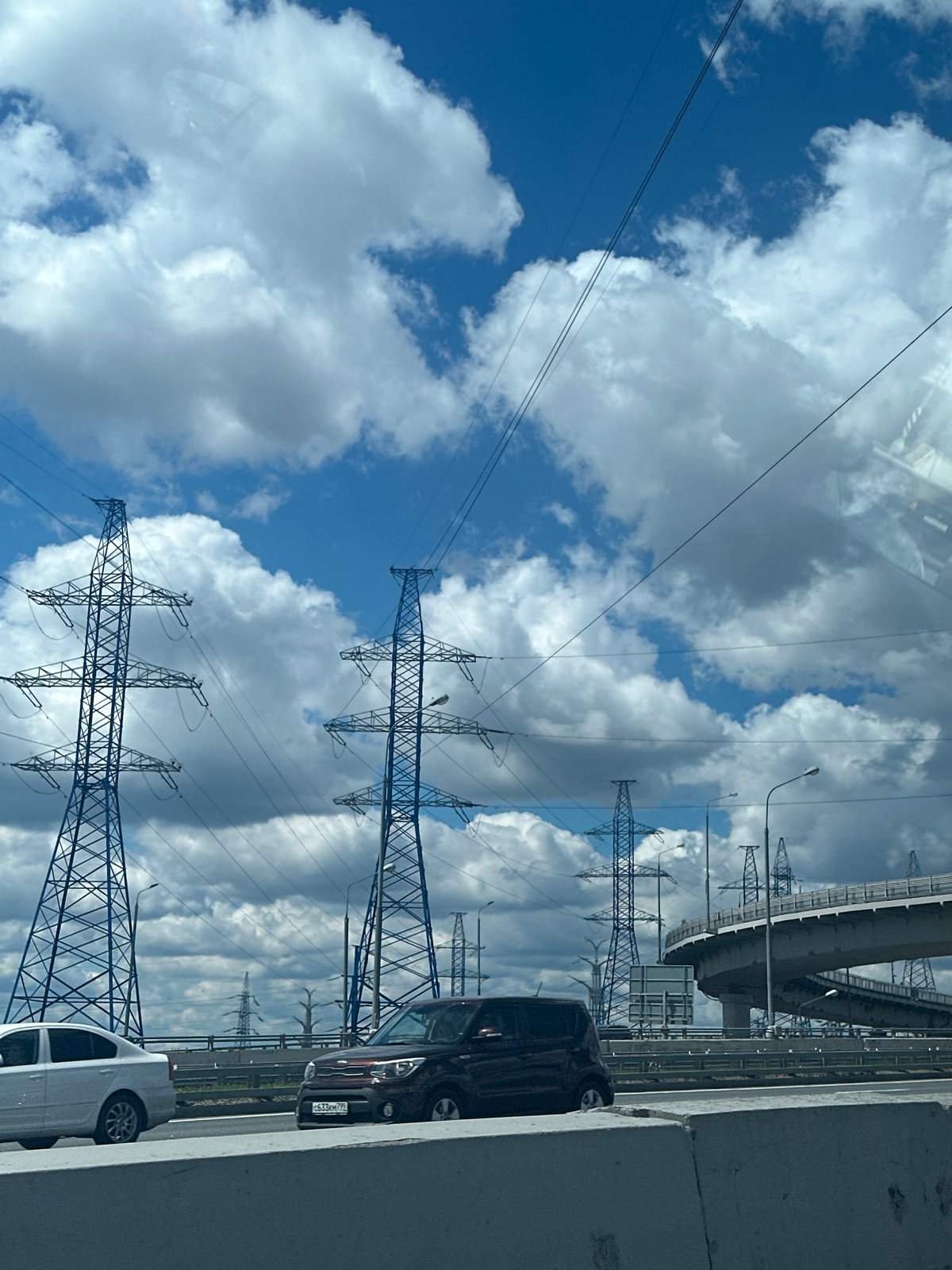 Highway drive past power infrastructure and an Orthodox church