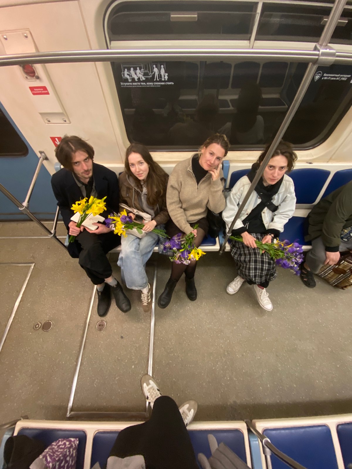 Four women with flowers ride Moscow subway together