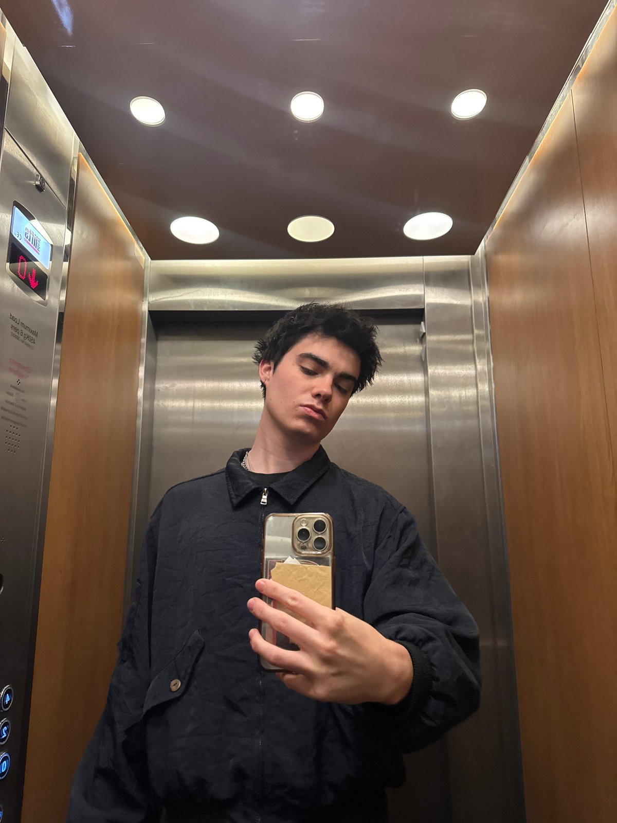 Young man takes relaxed elevator selfie in London