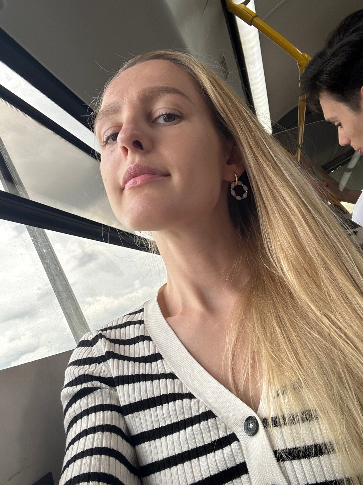 Selfie sequence on a bus, striped cardigan, 26 seconds apart