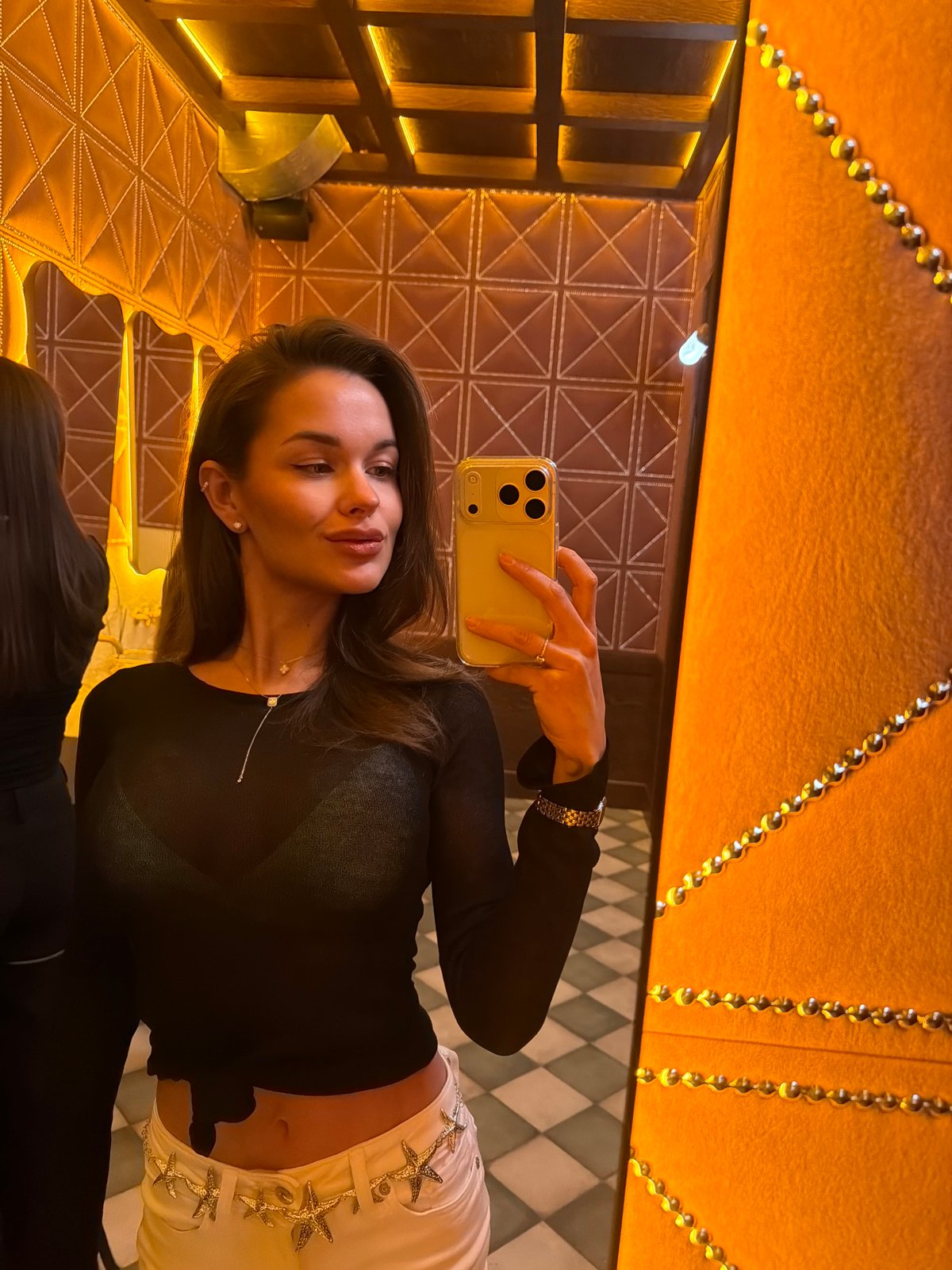 Woman takes selfie in upscale Krasnoyarsk interior