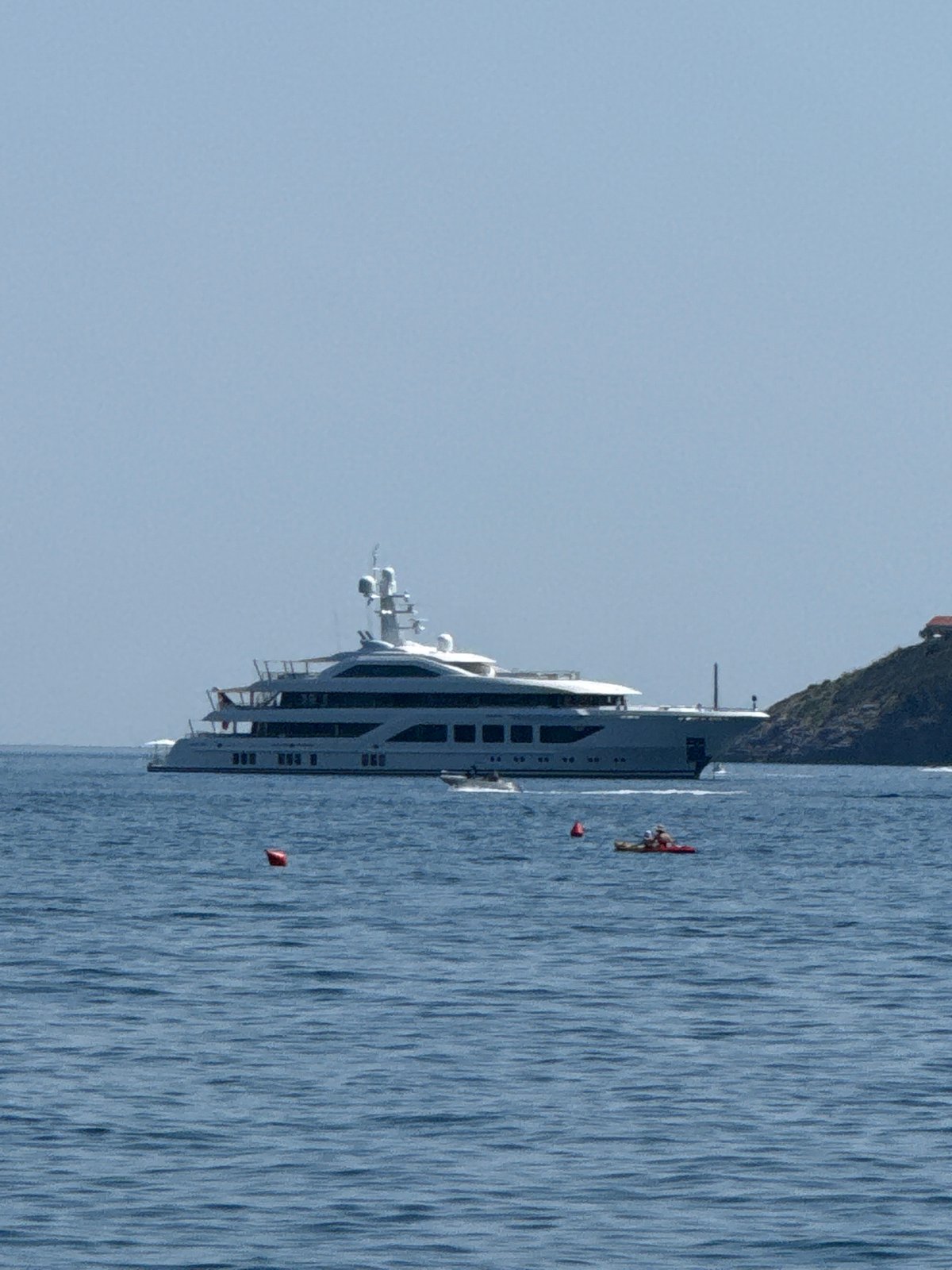 Budva's coastline in full summer swing — beaches, boats, and parasails