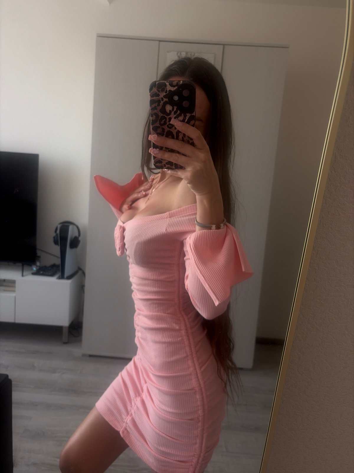 Person documents pink outfit in mirror selfies in Russia