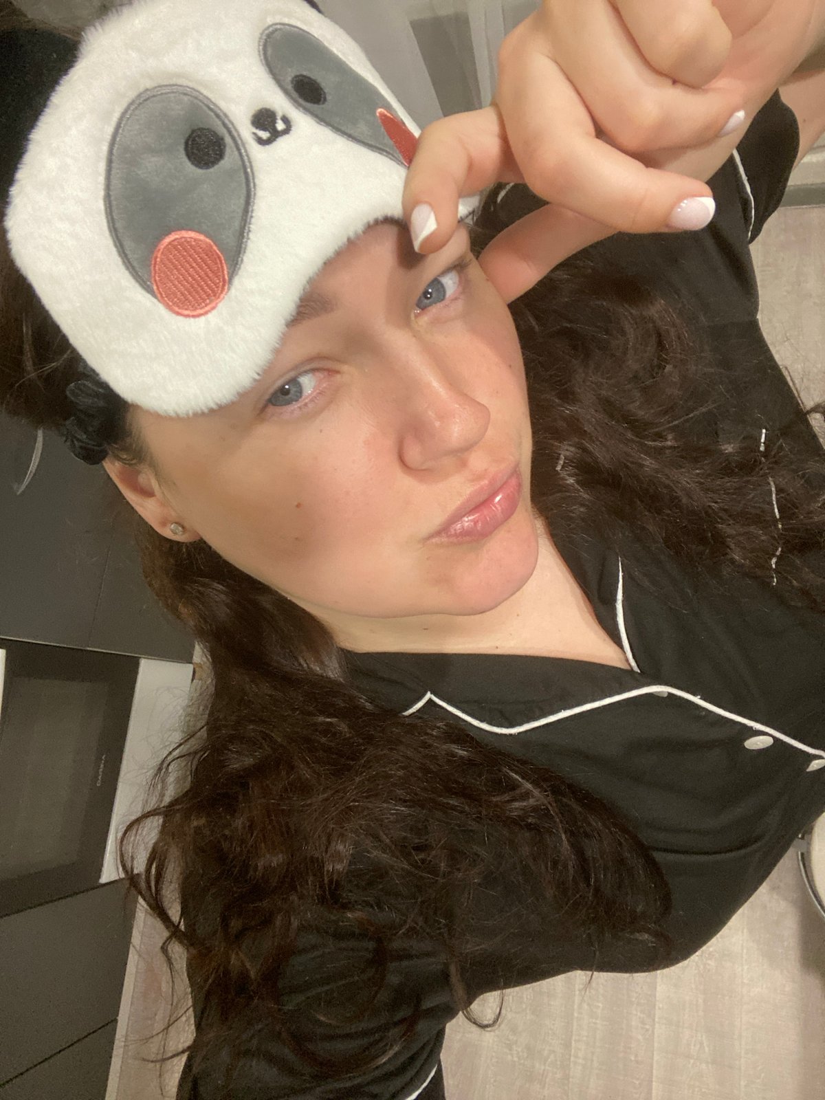 Woman in panda sleep mask captured in morning routine, Sochi