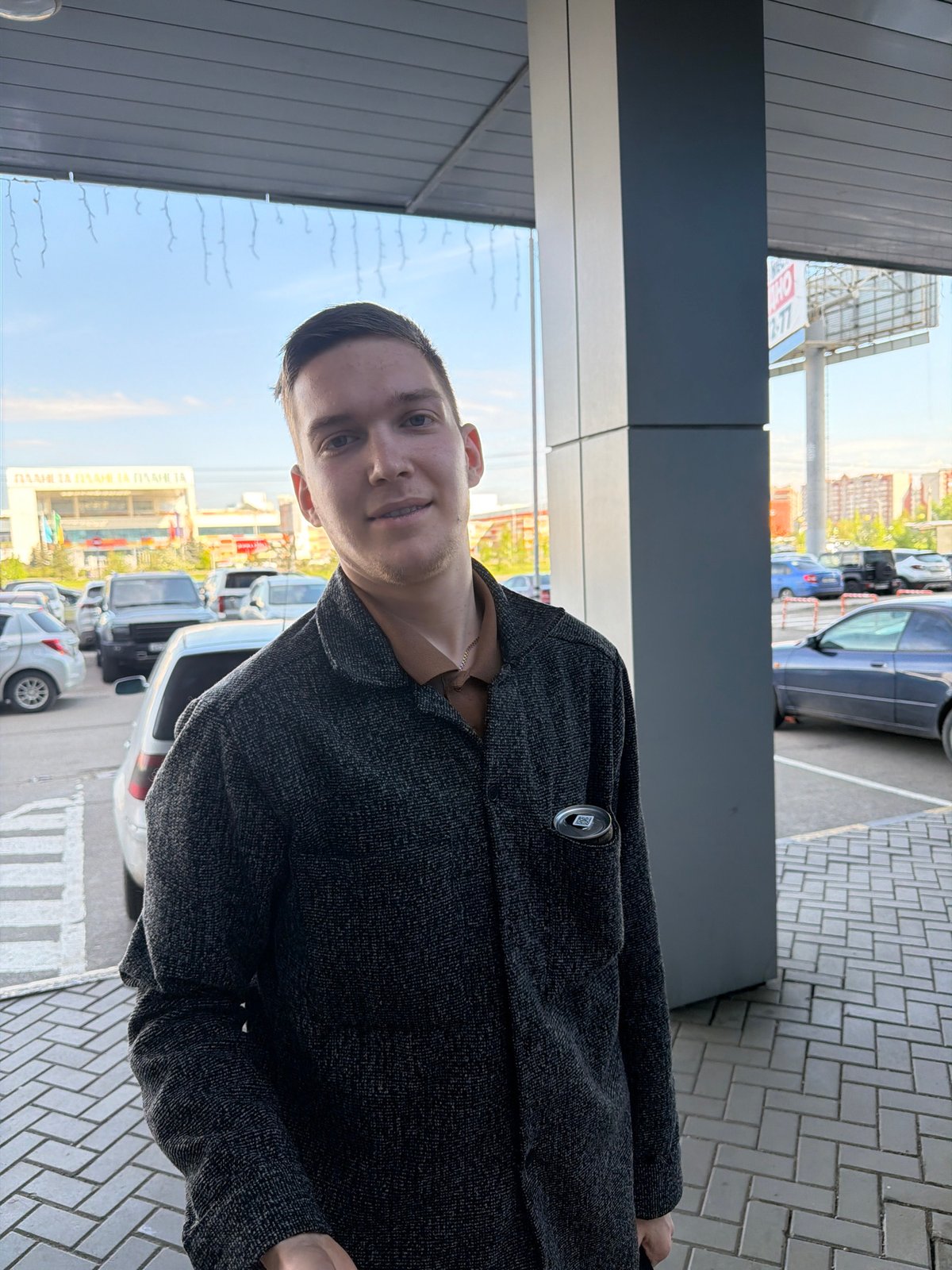 Man photographed on Krasnoyarsk street amid modern buildings