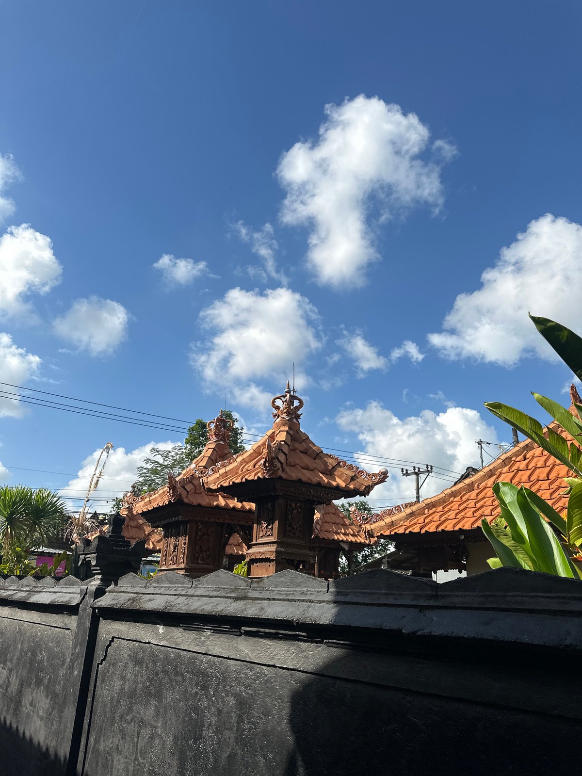 Rooftops, a sidewalk sign, and an open sky