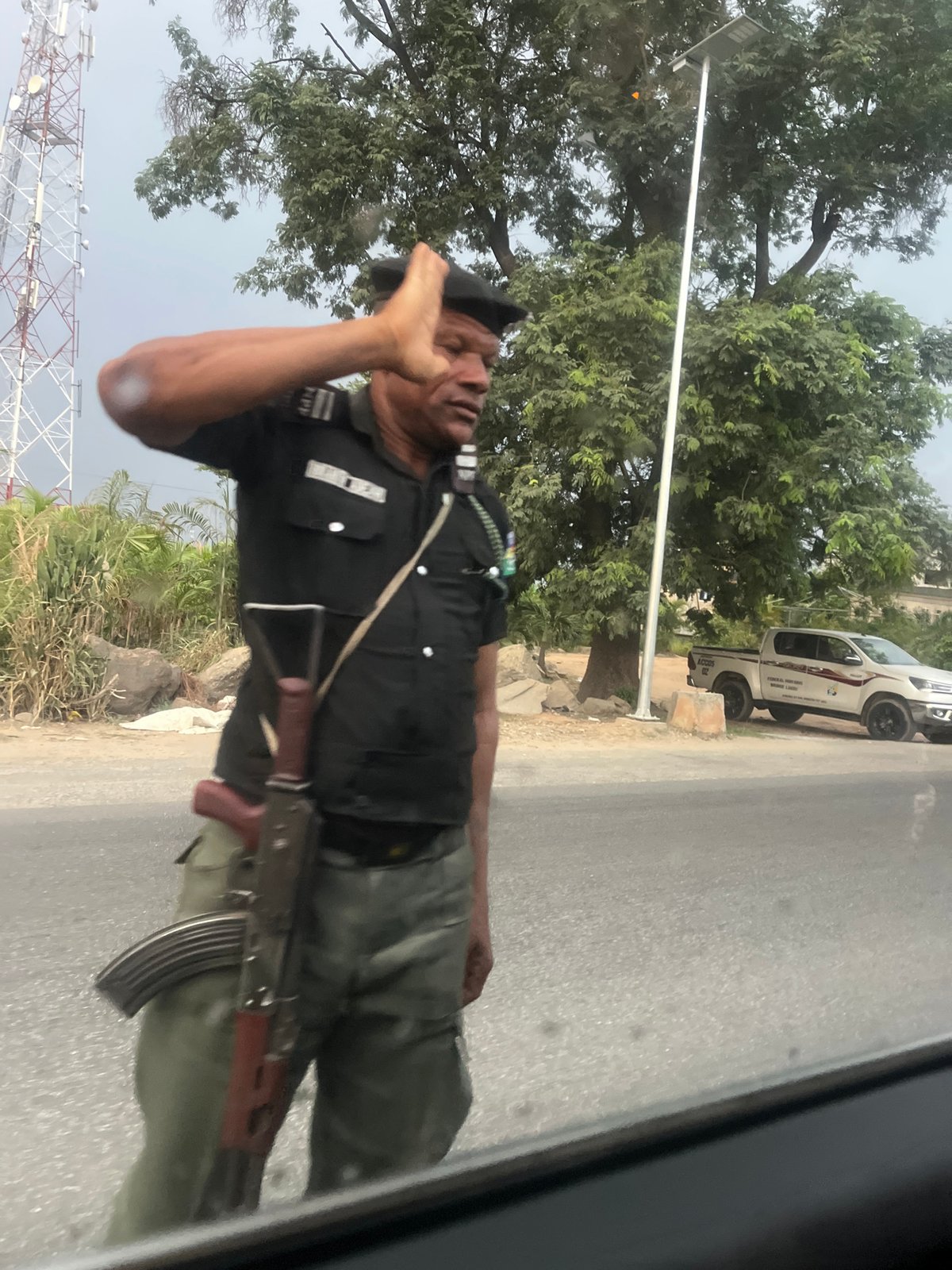 Nigerian Officer Salutes While Armed in Karu