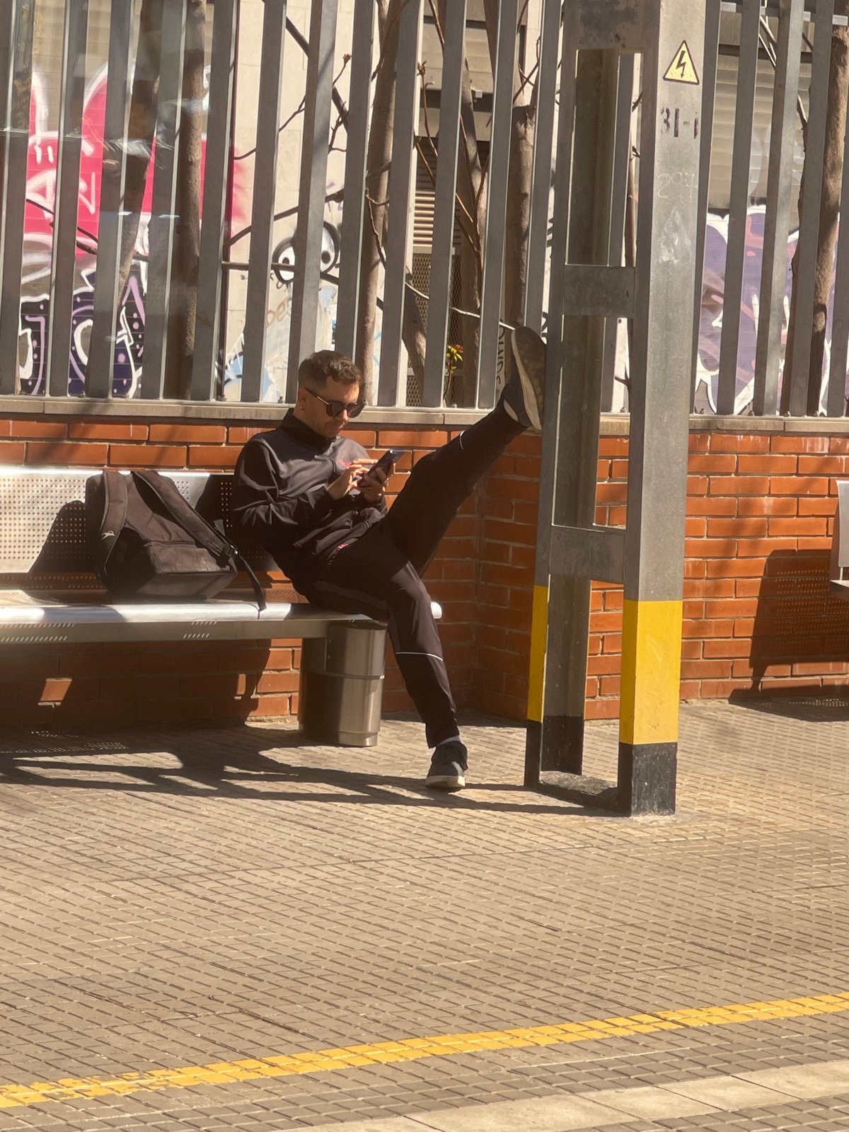 Man sits on public bench in Spanish town