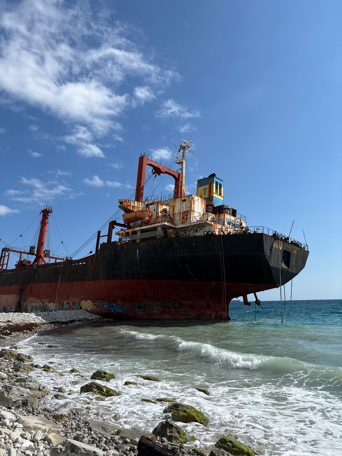 Rusted cargo ship 'RIO' beached on Kabardinka's rocky shore
