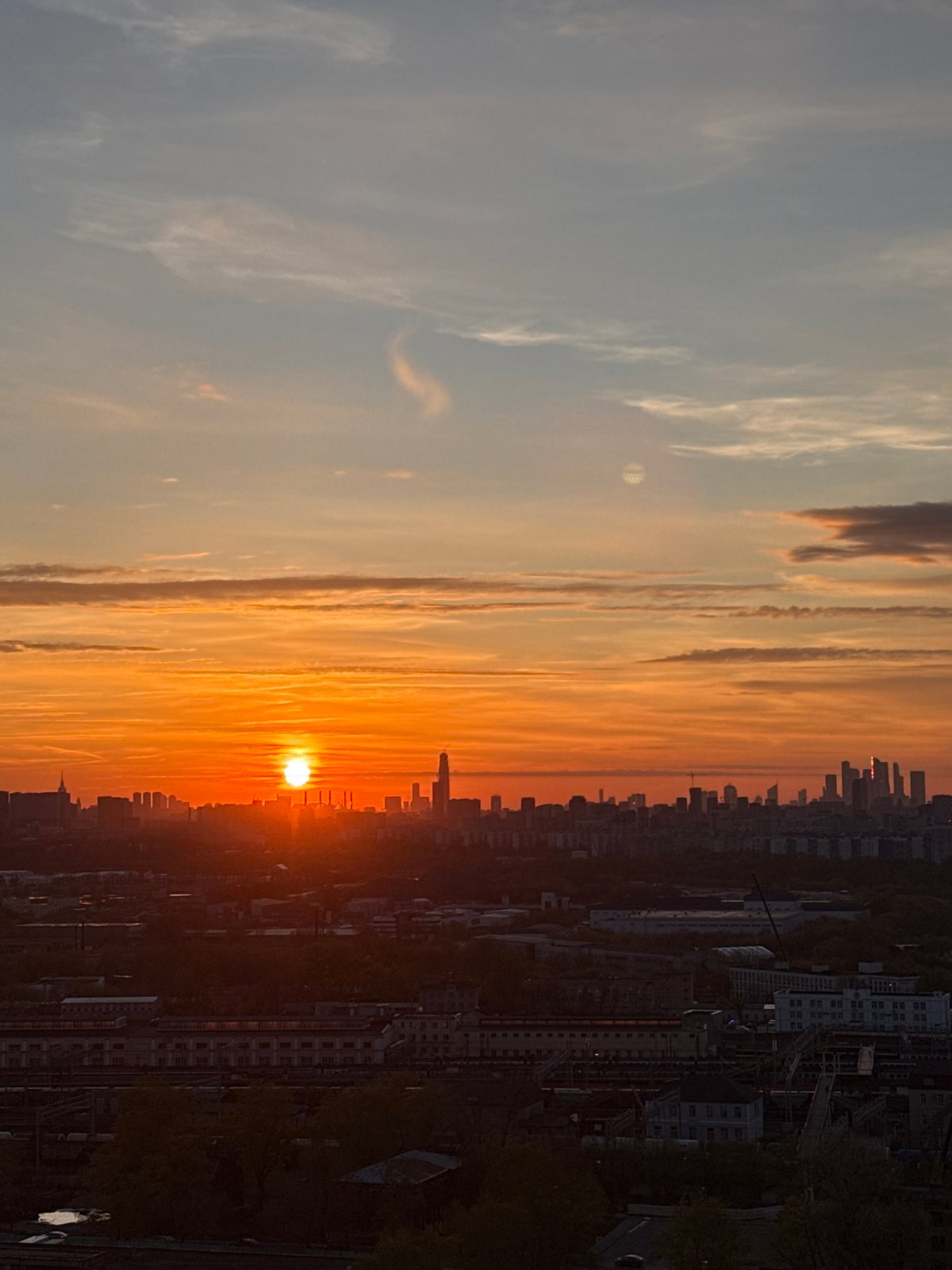 Moscow residents document sunset cityscape, indoor moment Saturday evening