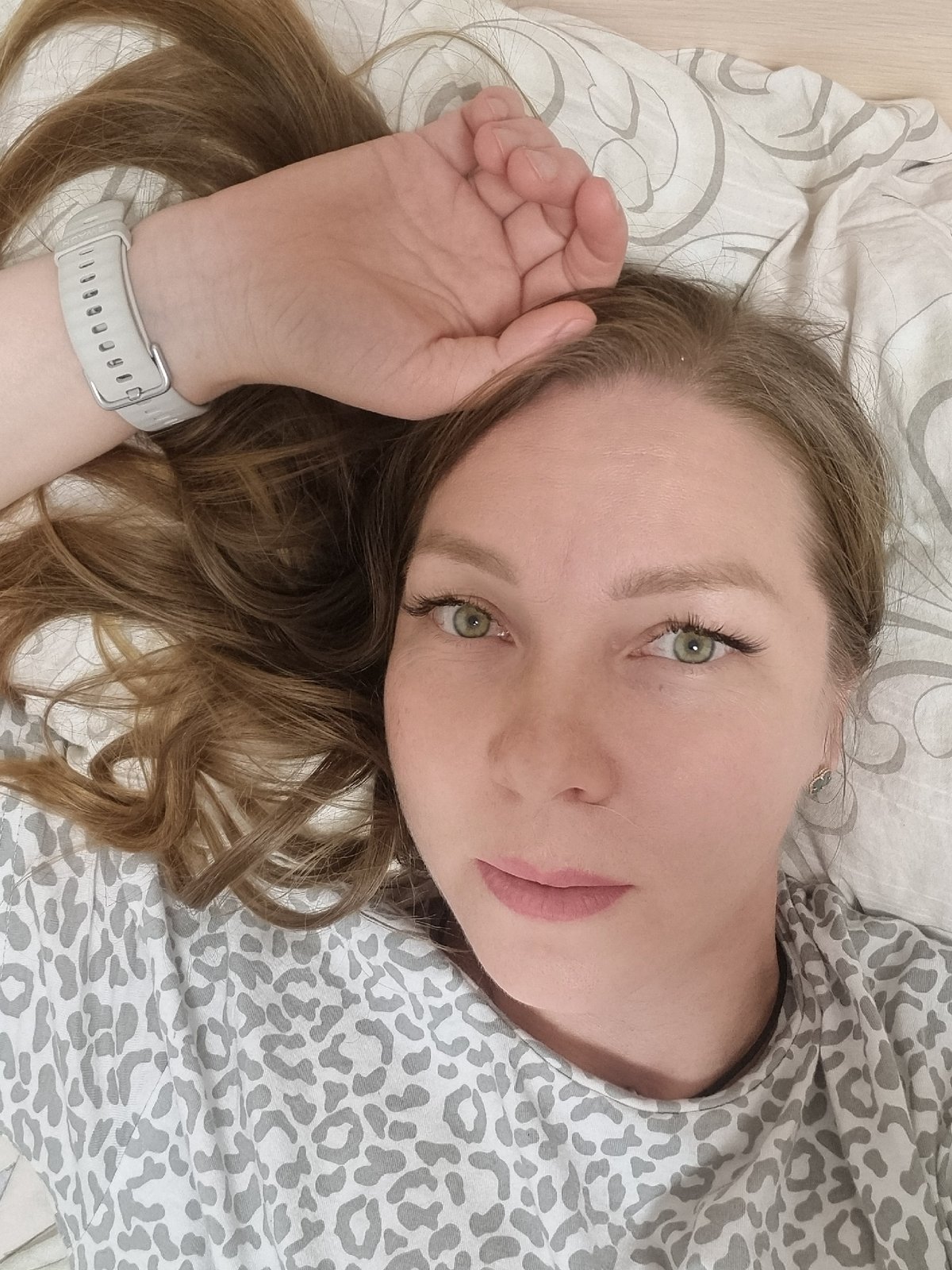 Woman resting on bed observed in Chaikovsky, Russia