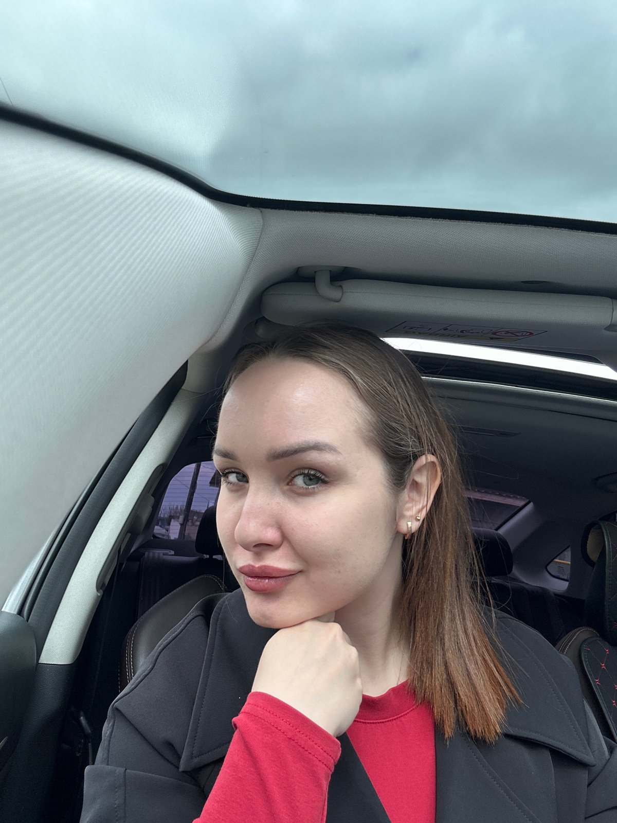 Woman photographed in car during early morning in Chaikovsky, Russia
