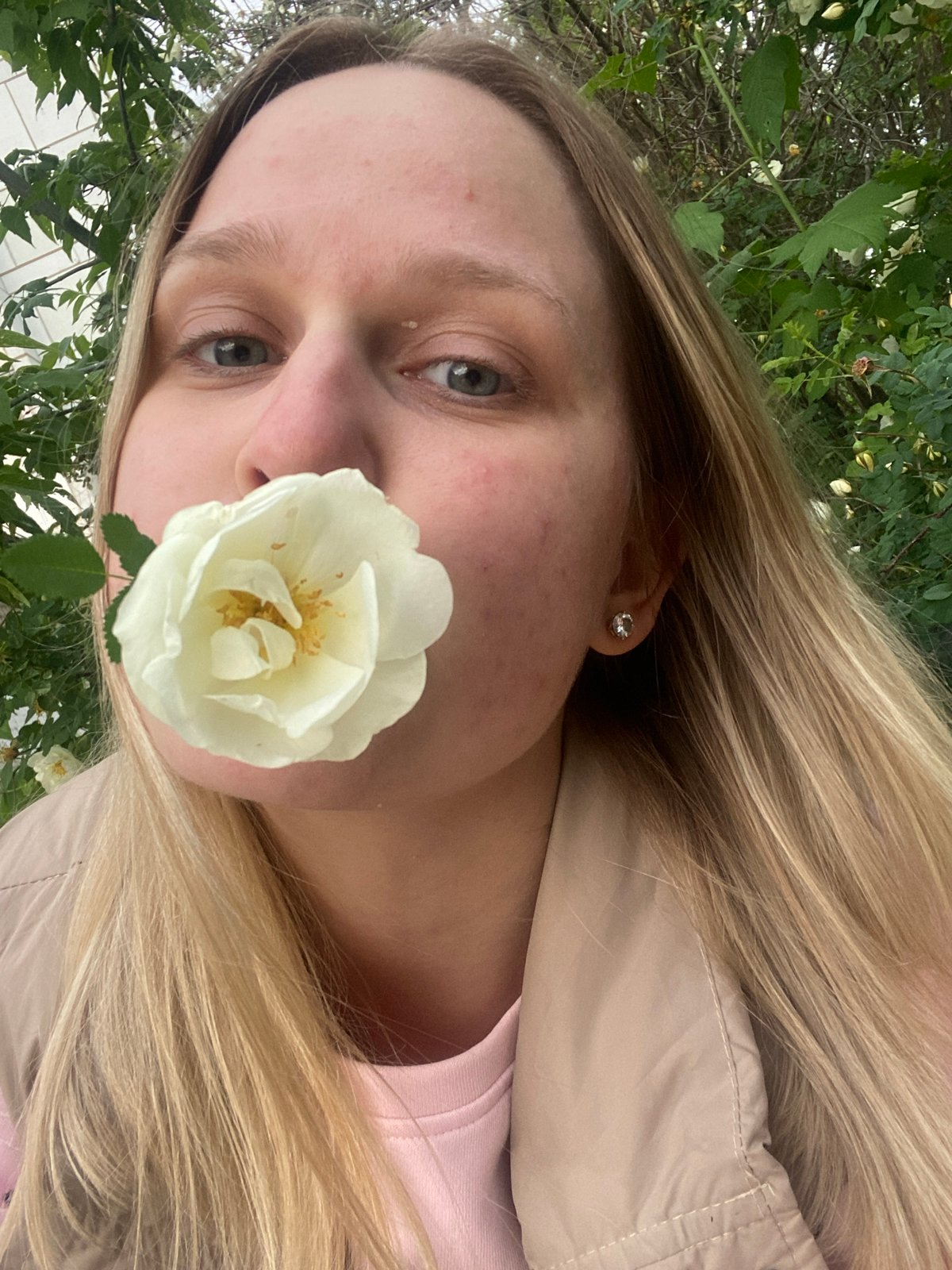 Woman poses among flowers during brief outdoor photo session