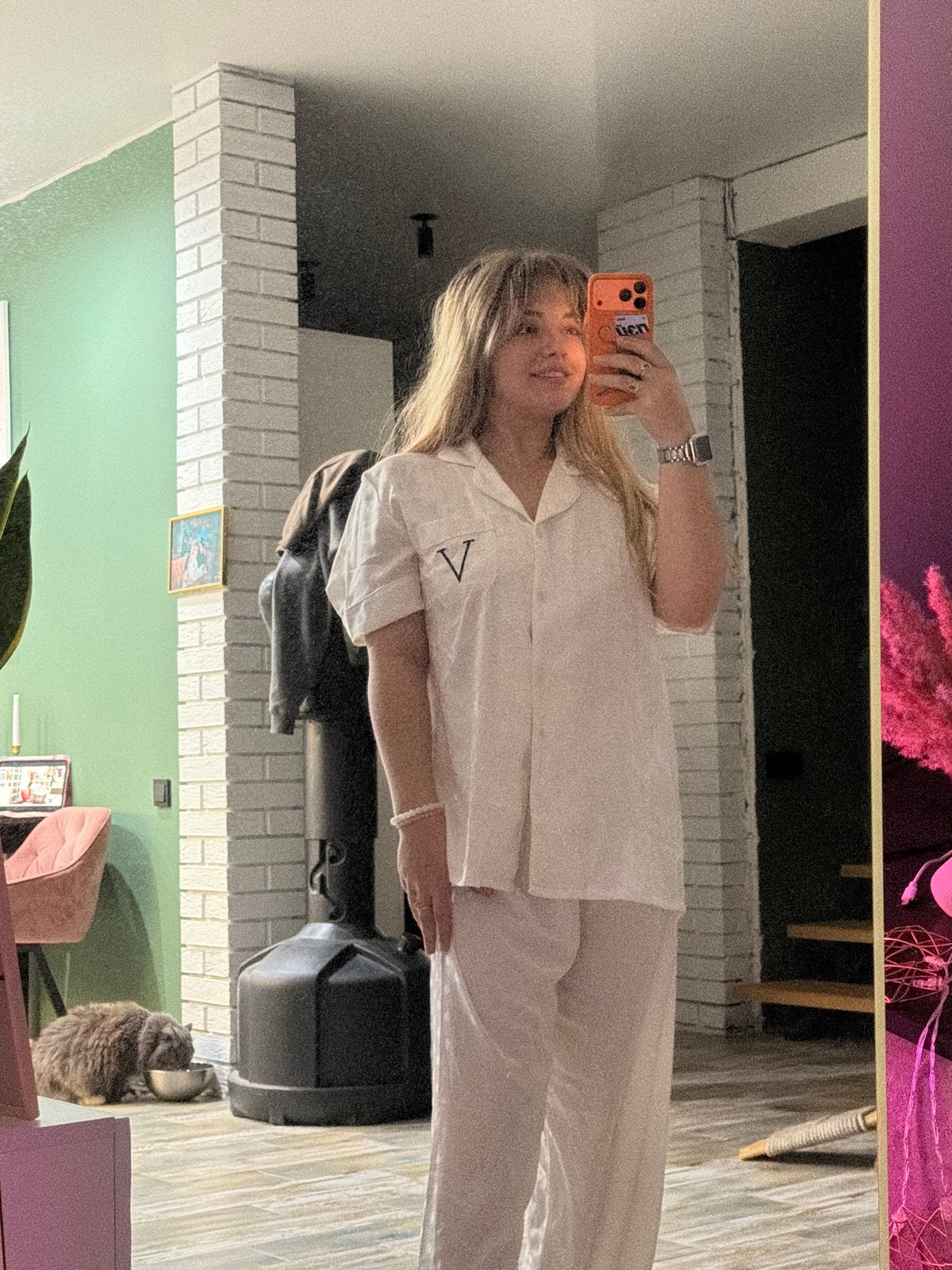 Woman takes mirror selfie in pajamas in Russian village