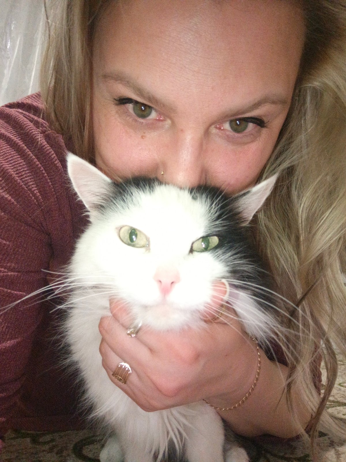 Woman and cat photographed at home in Markovskiy, Russia